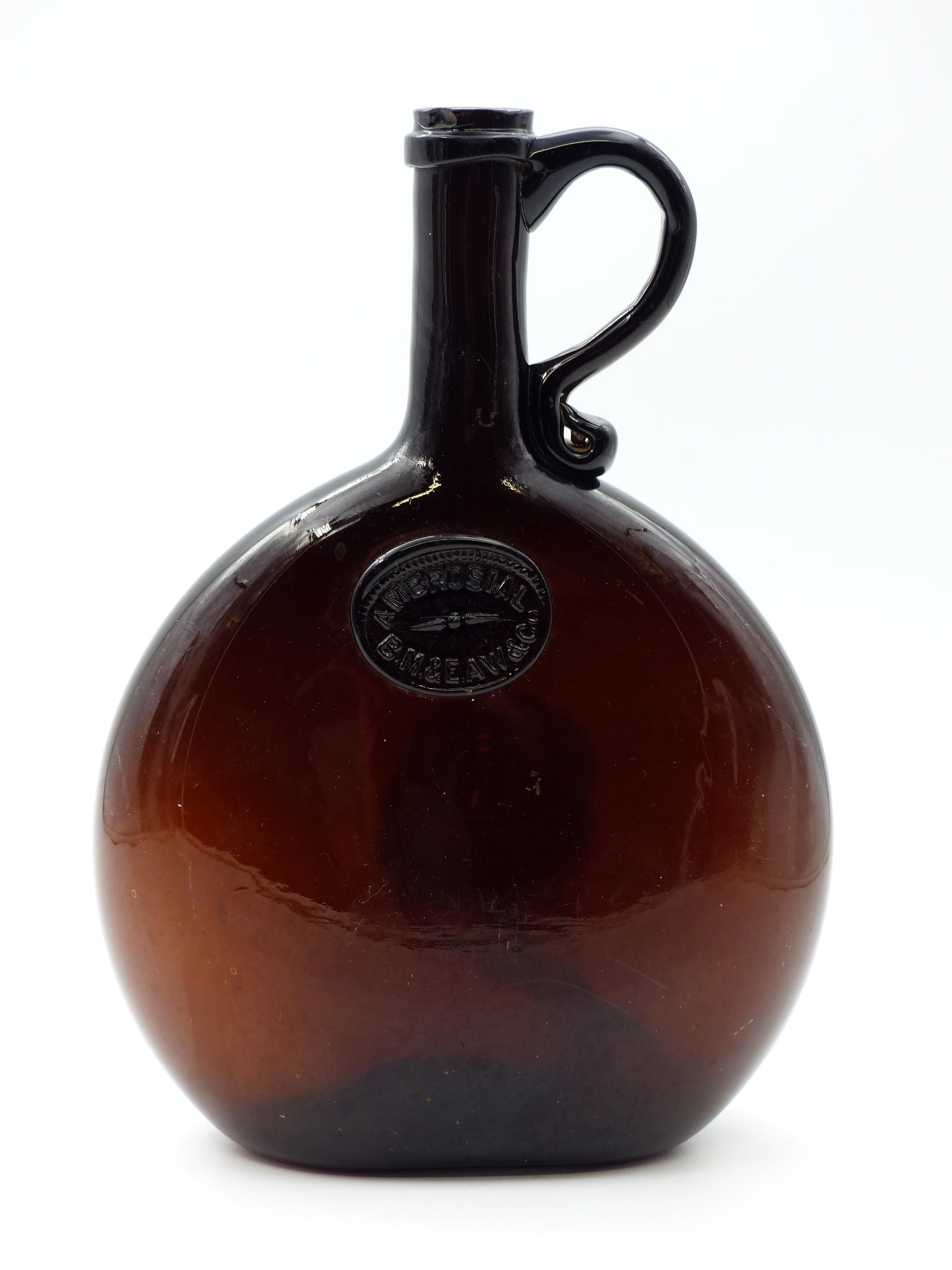 Ambrosial B.M.&e.Aw & Co Chestnut Bottle With Handle: Ambrosial B.M.&E.AW & Co Chestnut Bottle with Handle -Amber ; Condition: small chip on lip ; 8 3/4 "H