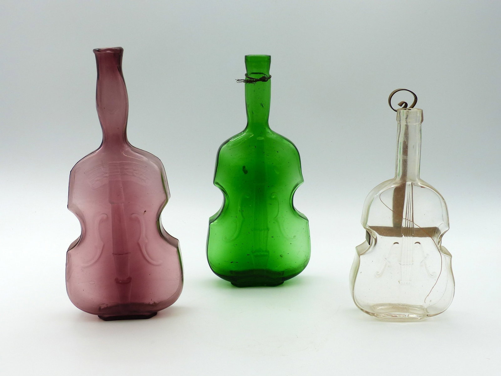 Violin Bottles: Violin bottles -green (9 1/2”); Purple (10”); clear (8”) ; Condition: Mint ;