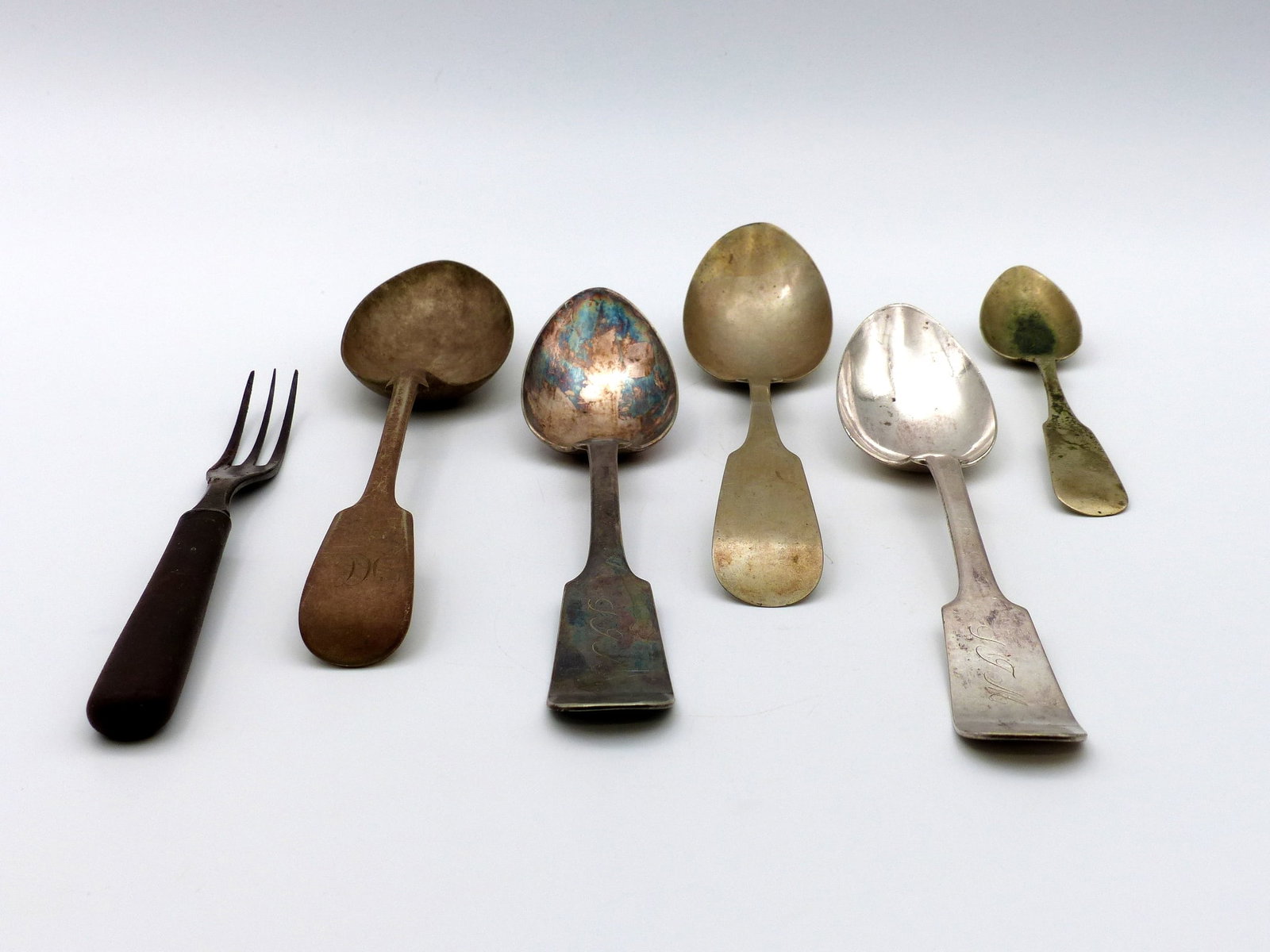 Four Old Serving Spoons; One Small Spoon; One Fork: Four old serving spoons; one small spoon; one fork -Condition: fair ;