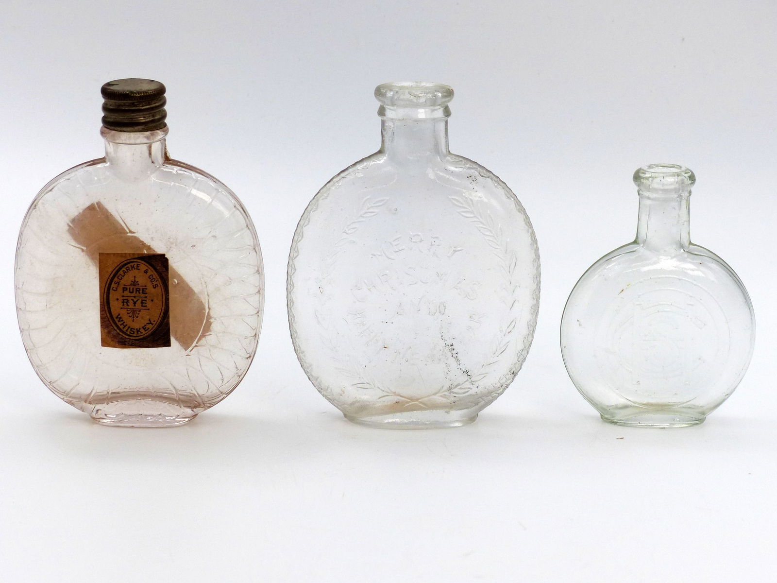 3 Small Pumpkin Seed Flasks; "pure Rye Whiskey"; "merry Christmas"; Embossed "chs": 3 Small Pumpkin Seed Flasks; "Pure Rye Whiskey"; "Merry Christmas"; Embossed "CHS" -4.5"; 3.5"; 3.5"H