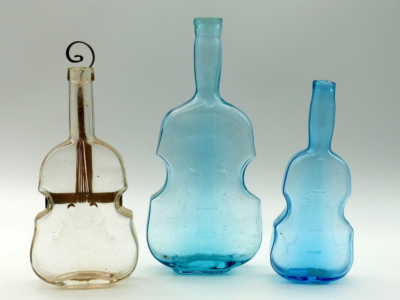 3 Violin Bottles: 3 Violin Bottles -2 Blue; 1 Clear ; Condition: Mint ; 7.25"; 9.625"; 8.75"H