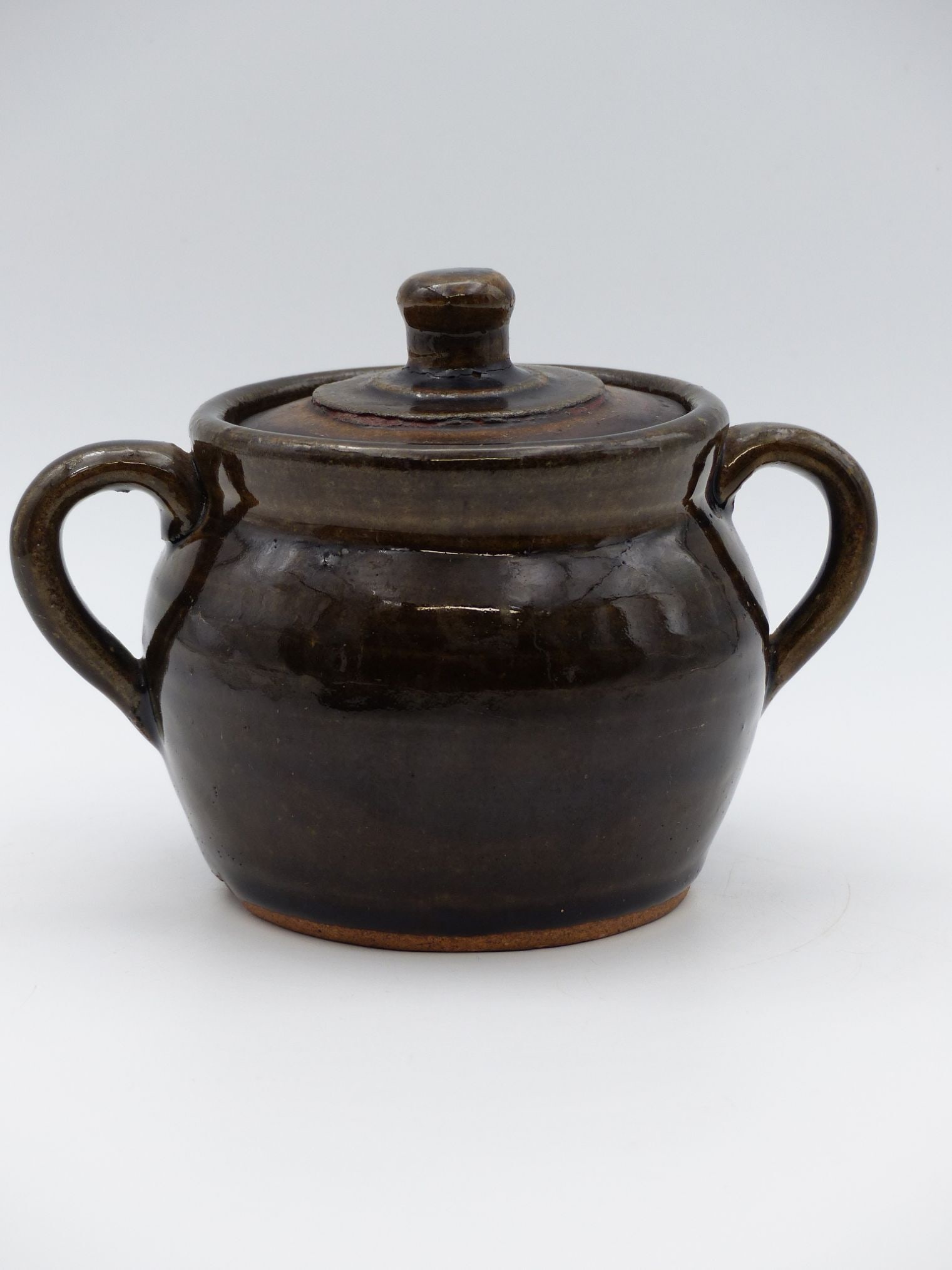 Aerie Meaders Two-Handle Sugar Bowl with Lid (A.M. Mark): The Aerie Meaders Two-Handle Sugar Bowl with Lid, marked with the A.M. insignia, showcases the distinctive craftsmanship of Meaders pottery. Characterized by its rich, earthy glaze and rounded form, t