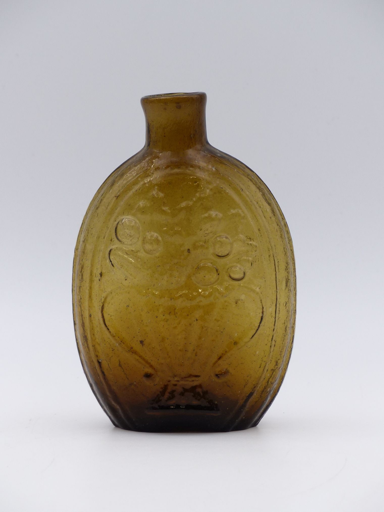 Vintage Glass Flask with Basket and Flower Motif: This exquisite vintage glass flask features a delightful motif of a basket brimming with flowers, masterfully crafted to highlight the artistry of hand-blown glassware. The flask's translucent amber c