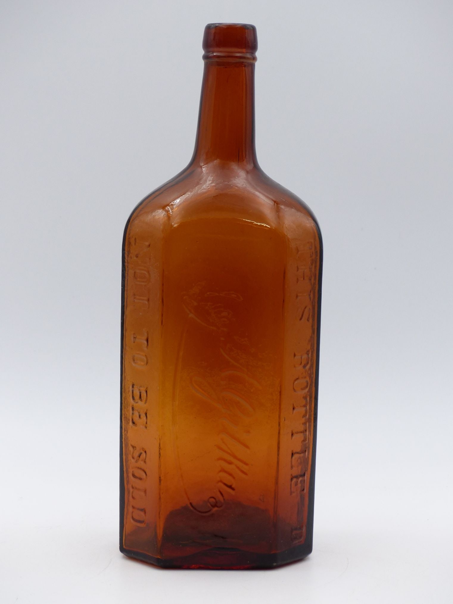SCHITZEN Berlin Amber Bottle (Store Display): This exquisite Schitzen Berlin Amber Bottle is a fascinating piece that serves both as a captivating store display and a significant collectible from the late 19th to early 20th century. The bottle bo