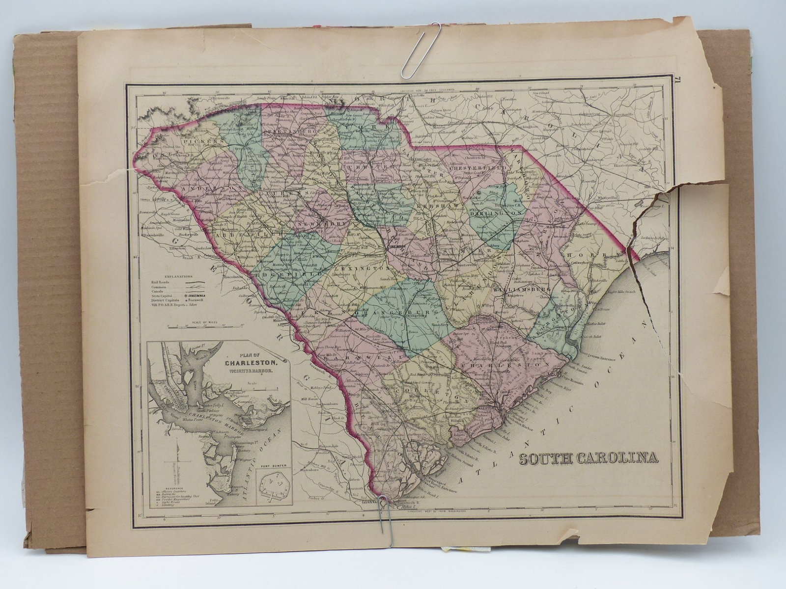 Antique Map of South Carolina: This is an antique map of South Carolina featuring a color-coded representation of counties and major cities. The map includes a detailed plan of Charleston and showcases the intricate network of rail