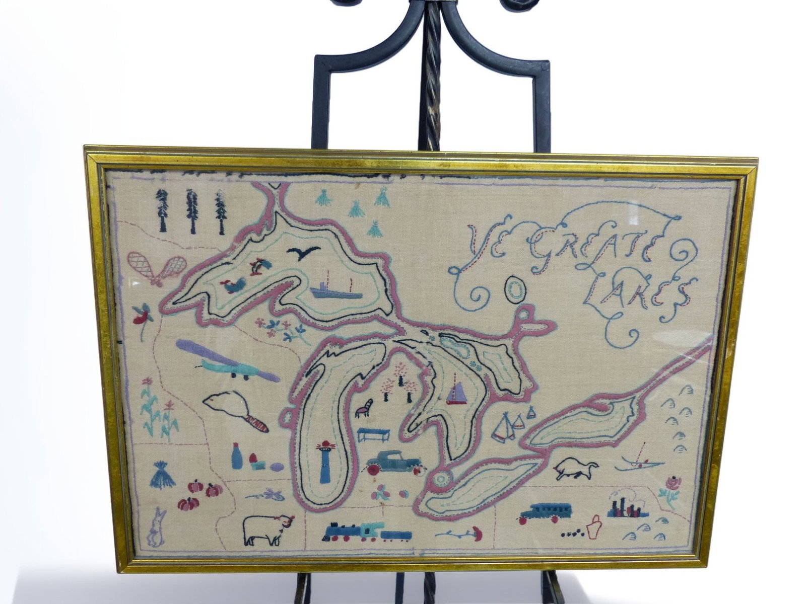 "Hand-Stitched Great Lakes Picture: This hand-stitched depiction of the Great Lakes is a charming illustration of the region's geography, complete with whimsical elements reflecting the local flora and fauna, as well as human activities