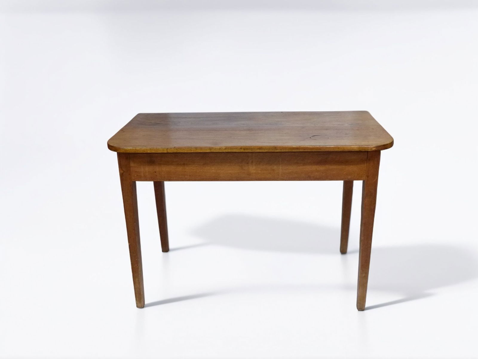 Walnut Pegged Table: This elegant walnut pegged table showcases craftsmanship from a bygone era, highlighting its clean lines and classic design. The tabletop's subtle grain and rich, warm tone provide an appealing contra