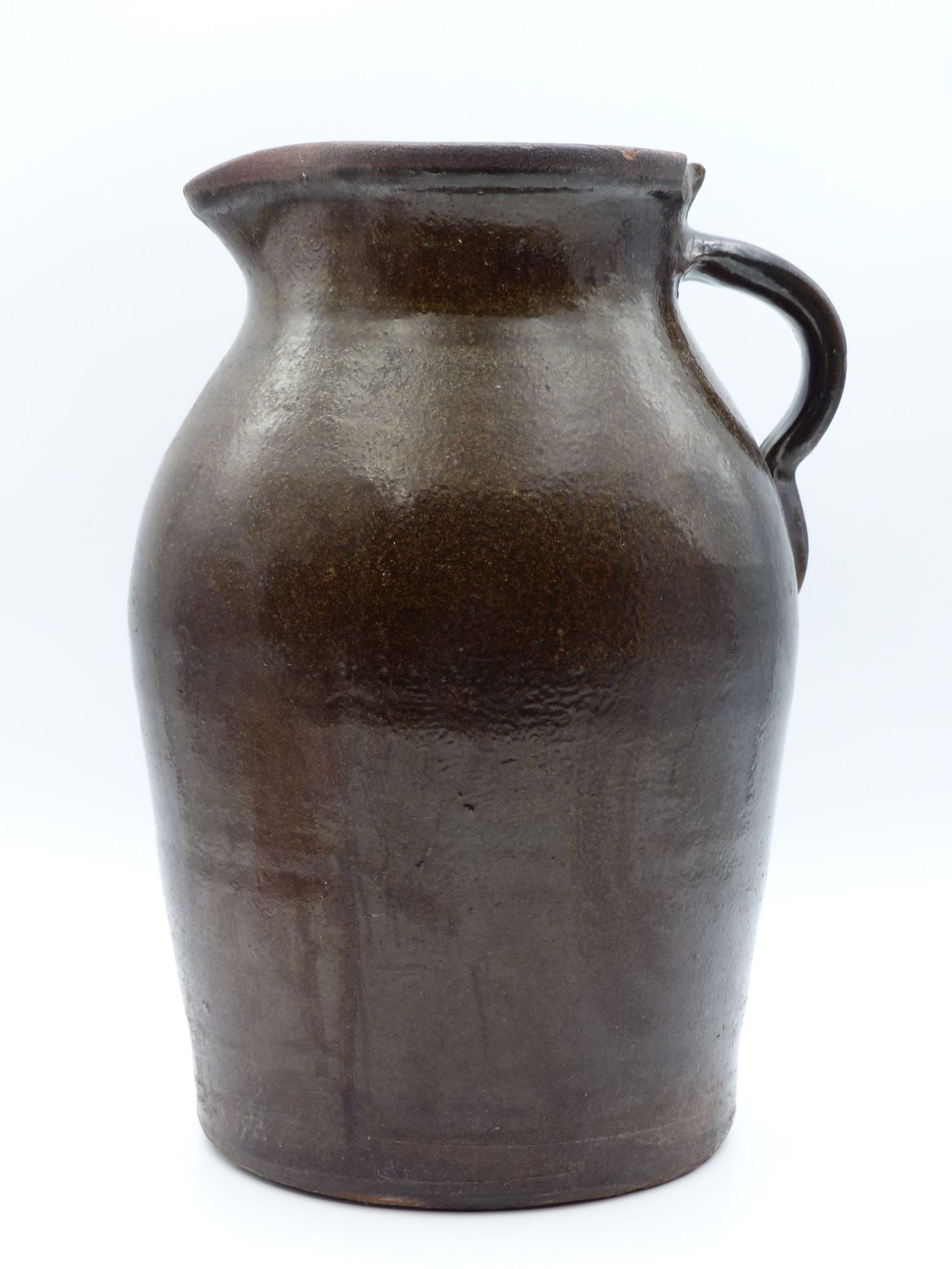 Clayton Factory 2-Gallon Alkaline Pitcher: This vintage Clayton Factory 2-gallon alkaline pitcher showcases traditional craftsmanship with its rich brown glaze and well-formed profile. The distinctive design features a gracefully curved body e