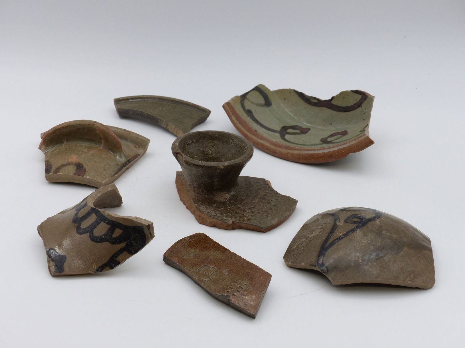 Trap & Chandler Decorated Shard Collection: This captivating collection of decorated shards features a variety of ceramic fragments, showcasing intricate designs and craftsmanship typical of their period. The assortment includes pieces with uni