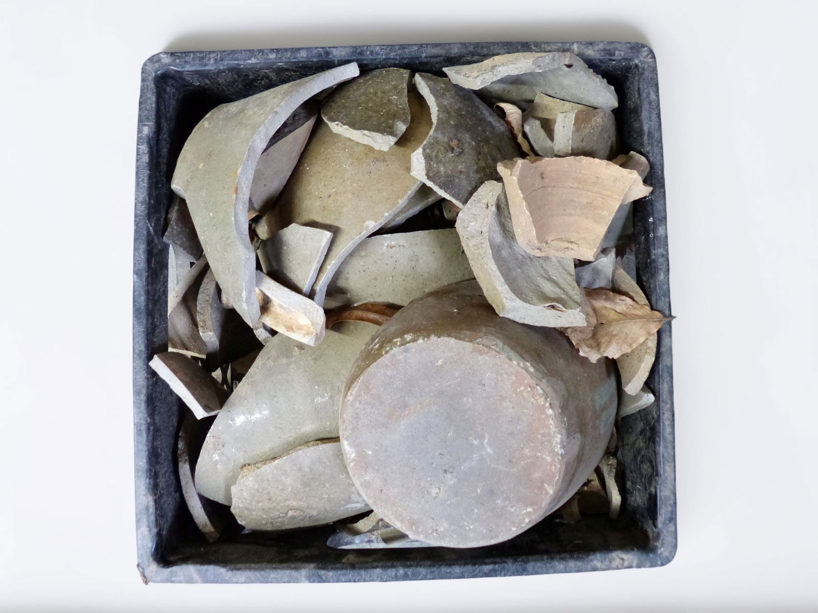 Trap & Chandler 5-Gallon Shard Bucket: This lot features a 5-gallon shard bucket, notable for its historical significance and unique assembly of ceramic fragments. Each shard showcases a mix of colors and textures, indicative of age and cr