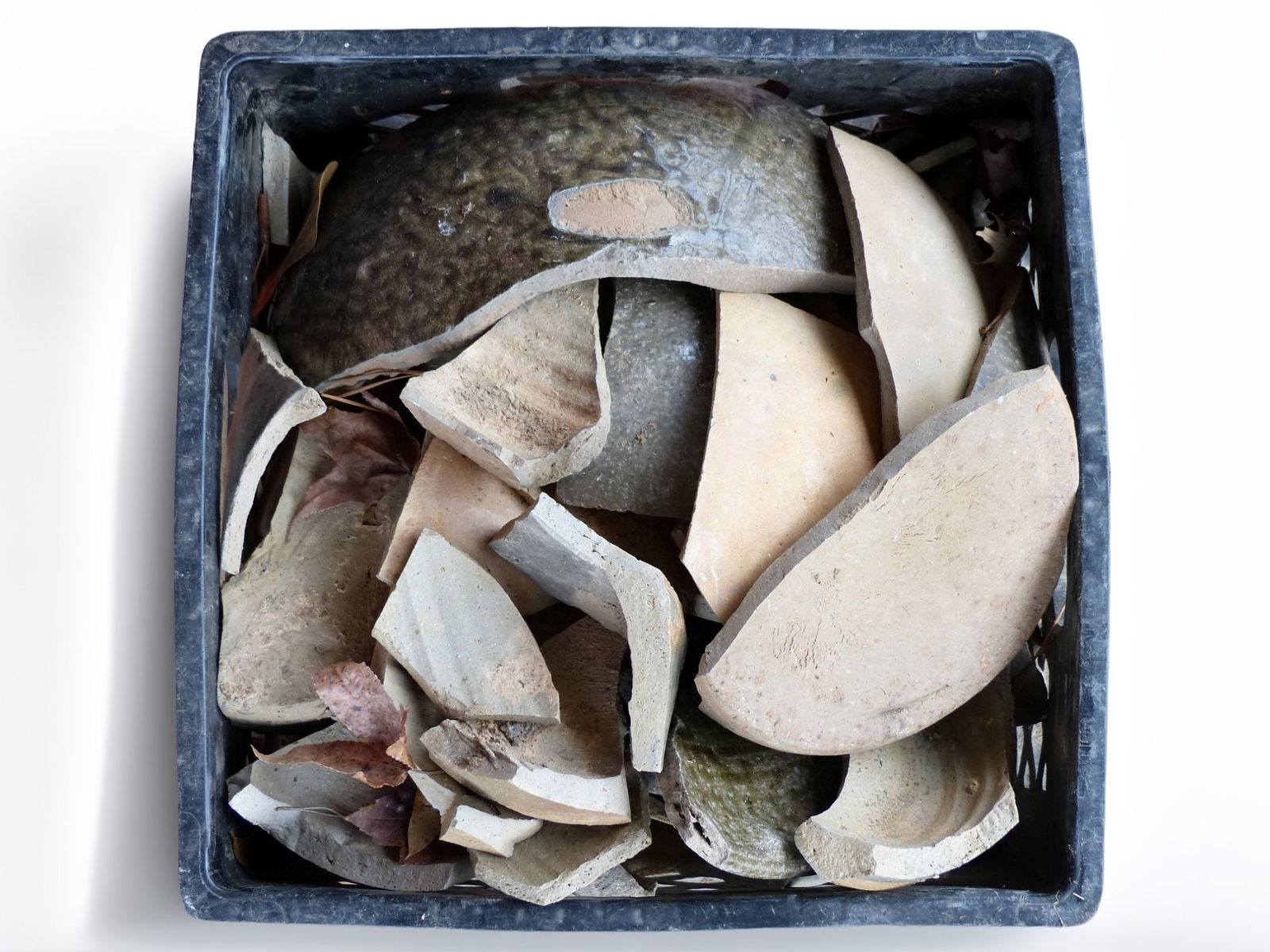 Trap & Chandler Pottery Shards: This lot features an intriguing collection of Trap and Chandler pottery shards, showcasing a variety of forms and textures that highlight the craftsmanship of historic ceramic art. The pieces, which e