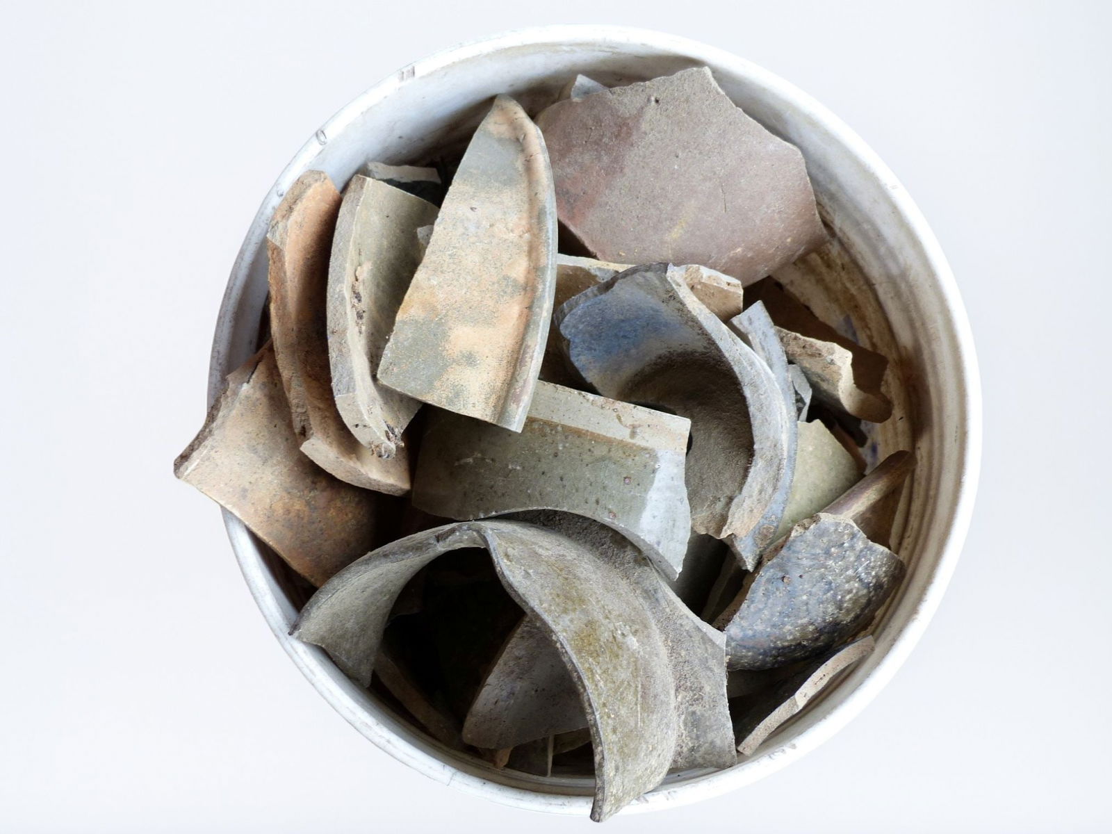 Trap & Chandler Pottery Shards: This collection of Trap & Chandler pottery shards showcases a variety of fragments, each offering a glimpse into the intricate designs and craftsmanship of early ceramics. The shards display a blend o