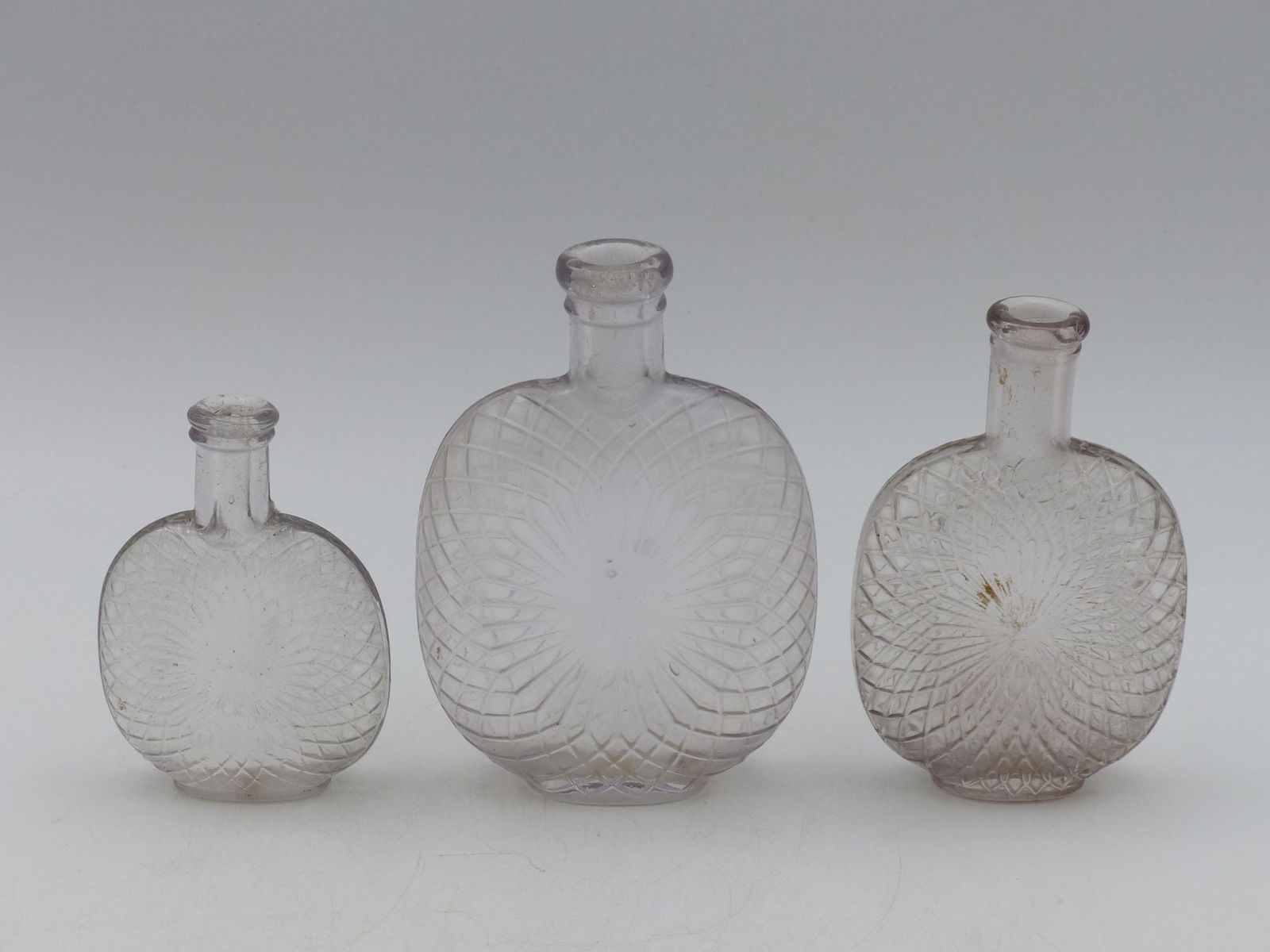Pumpkin Seed Spider Web Flask Collection: This exquisite Pumpkin Seed Spider Web Flask Collection features three elegantly crafted glass flasks, embodying the intricate artistry of vintage glassmaking. Each flask showcases a distinctive spide