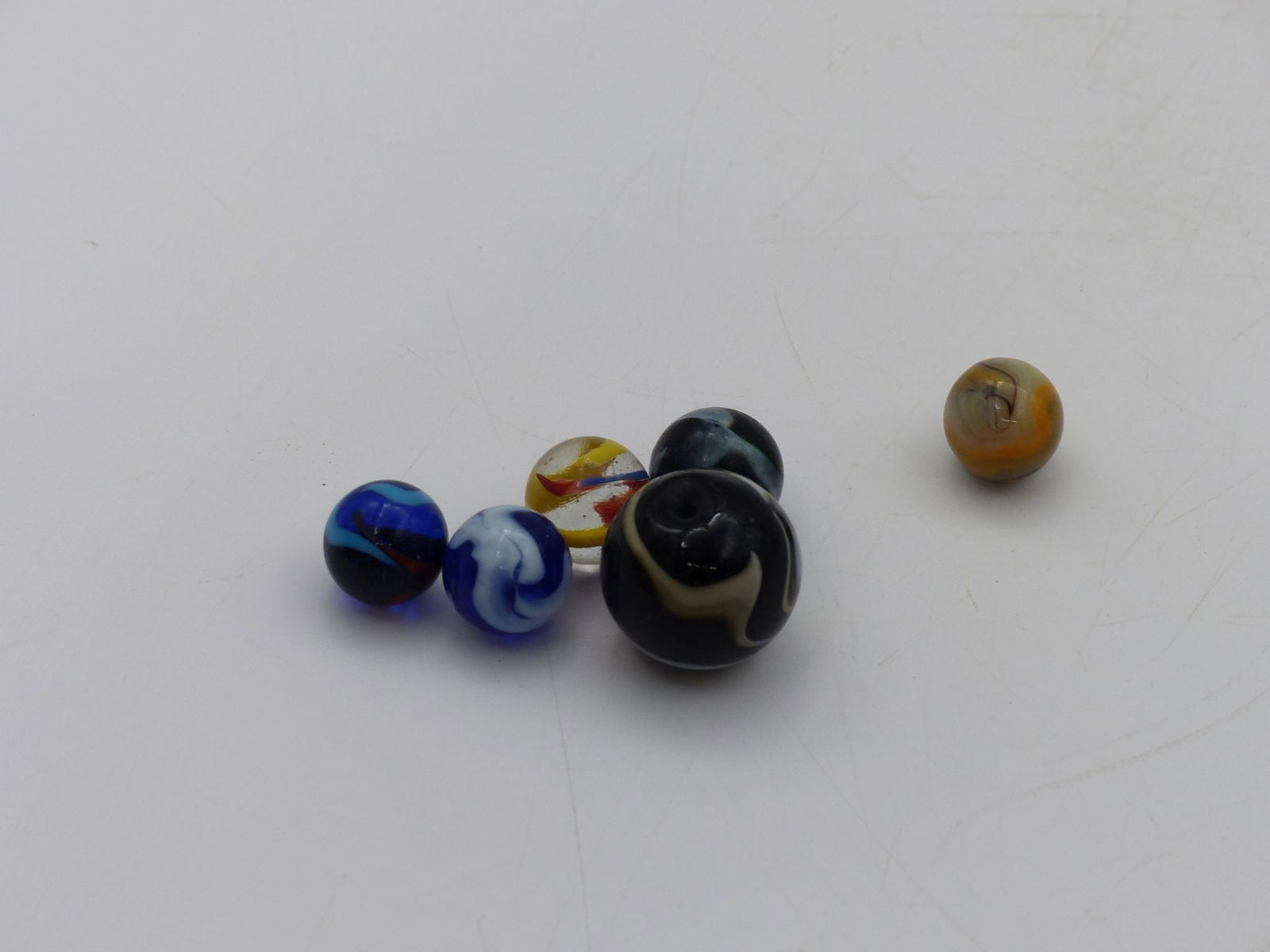 Marble Collection (Six Quality Pieces): This exquisite Marble Collection features six unique pieces, crafted with vibrant colors and intricate designs, showcasing a delightful array of craftsmanship. Each marble exhibits distinct patterns a