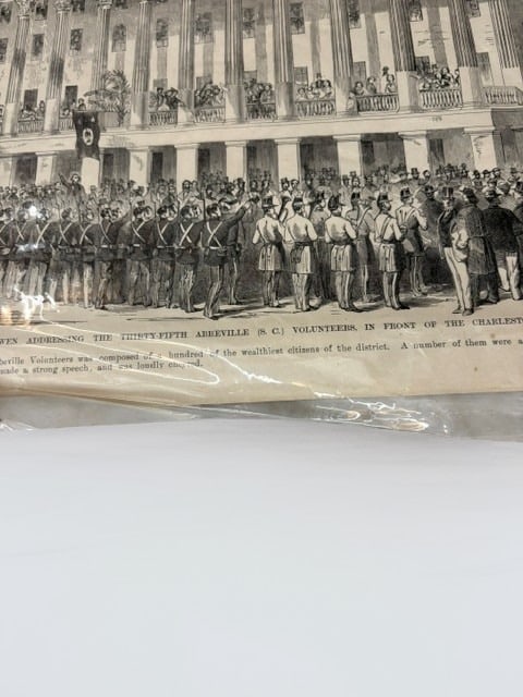General McQueen Addressing the Thirty-Fifth Abbeville Volunteers Print: This antique black-and-white engraving depicts a historical scene of General McQueen addressing the Thirty-Fifth Abbeville (S.C.) Volunteers in front of the Charleston Hotel. The detailed print illust