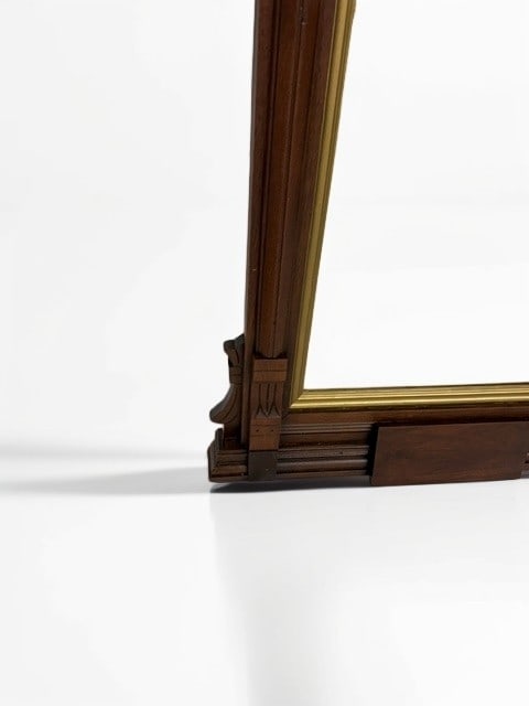 Victorian Walnut Pier Mirror with Architectural Detailing: This elegant Victorian pier mirror features a rich walnut frame characterized by refined architectural elements, including column-like side pilasters and rosette carvings at the upper corners. The