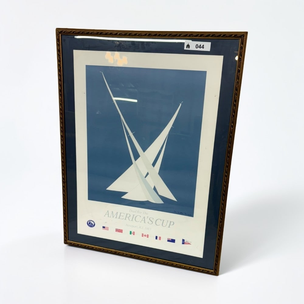 Vintage 1983 America's Cup Newport Framed Poster: This vintage poster commemorates the 1983 America's Cup sailing competition held in Newport, Rhode Island. The minimalist design features two stylized racing yachts set against a deep blue background 