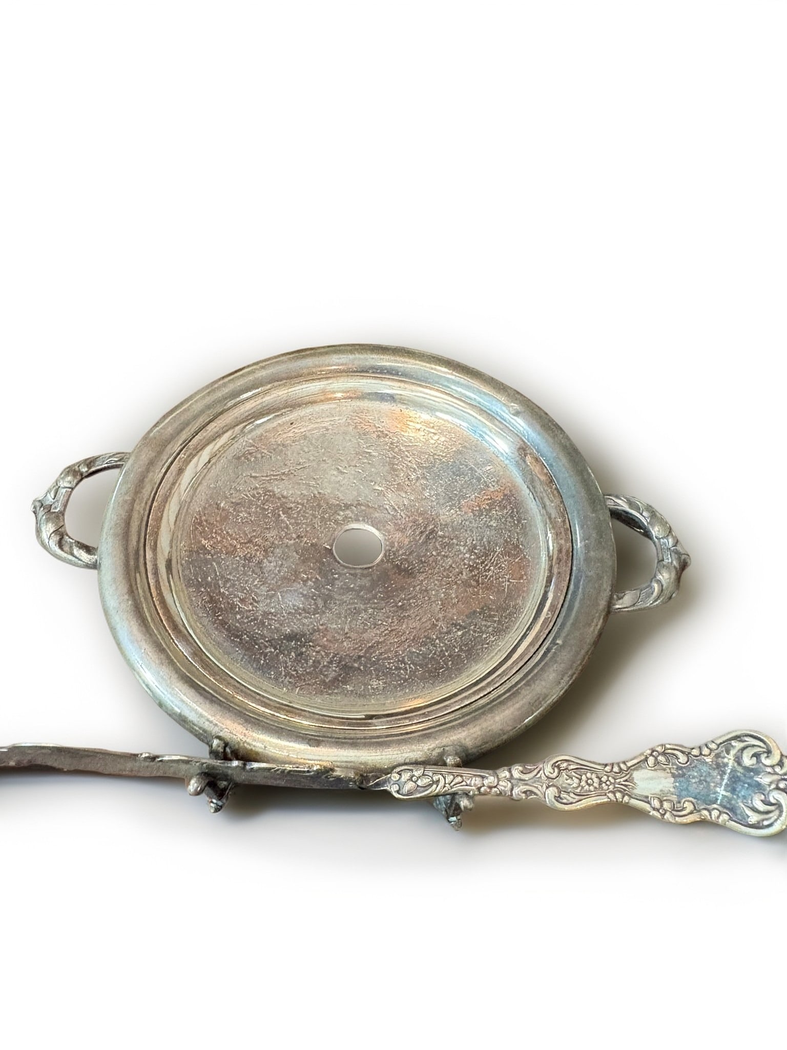 Silver Plated Butter Dish with Spreader: This elegant silver-plated butter dish features a classic domed lid with a decorative handle and integrated side handles on the base for easy serving. The set includes a matching ornate silver-plated 