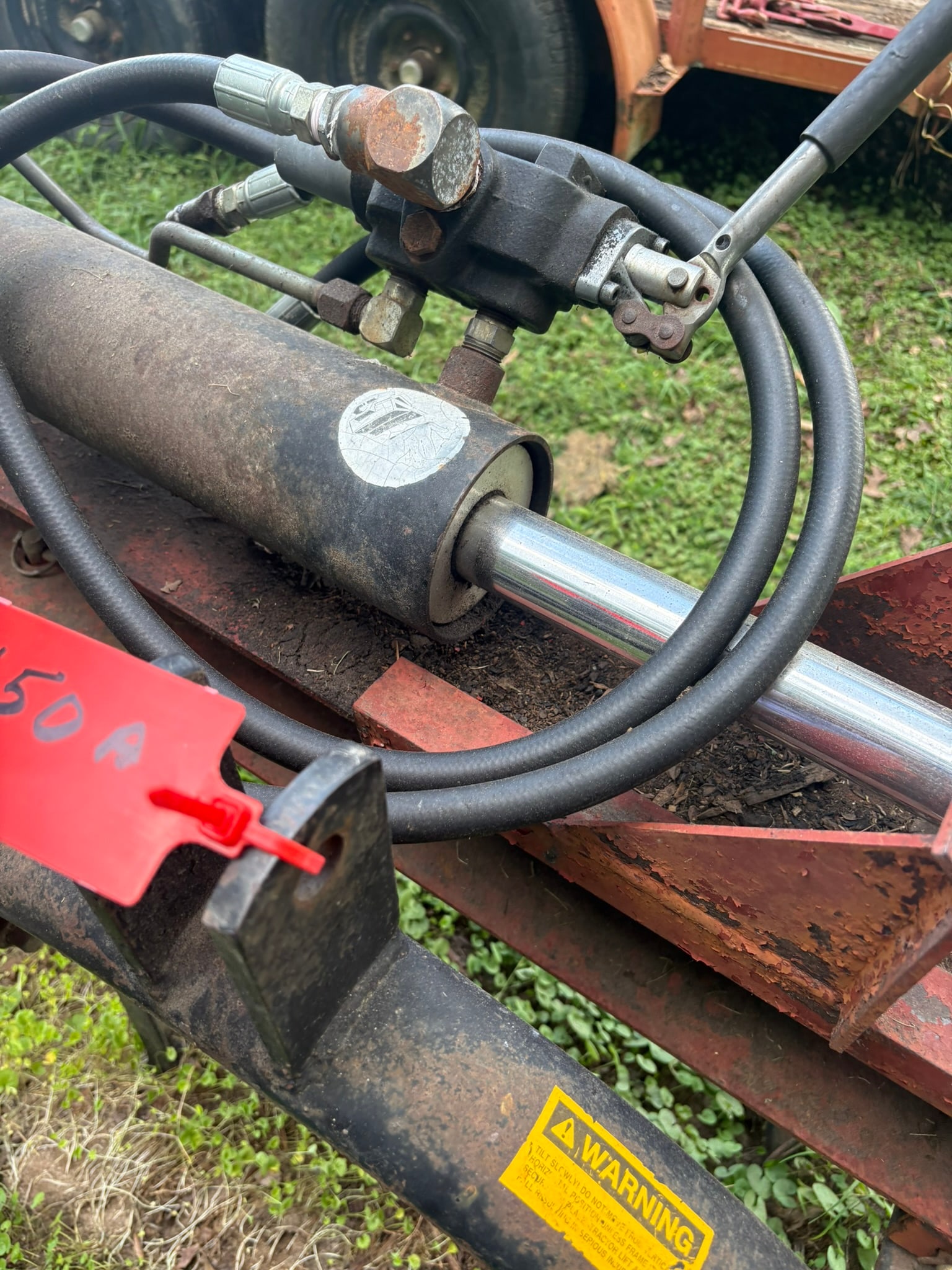 Hydraulic Log Splitter Attachment: This is a heavy-duty hydraulic log splitter attachment, designed for reliable operation in rugged outdoor environments. It features a robust steel frame construction, a high-pressure hydraulic