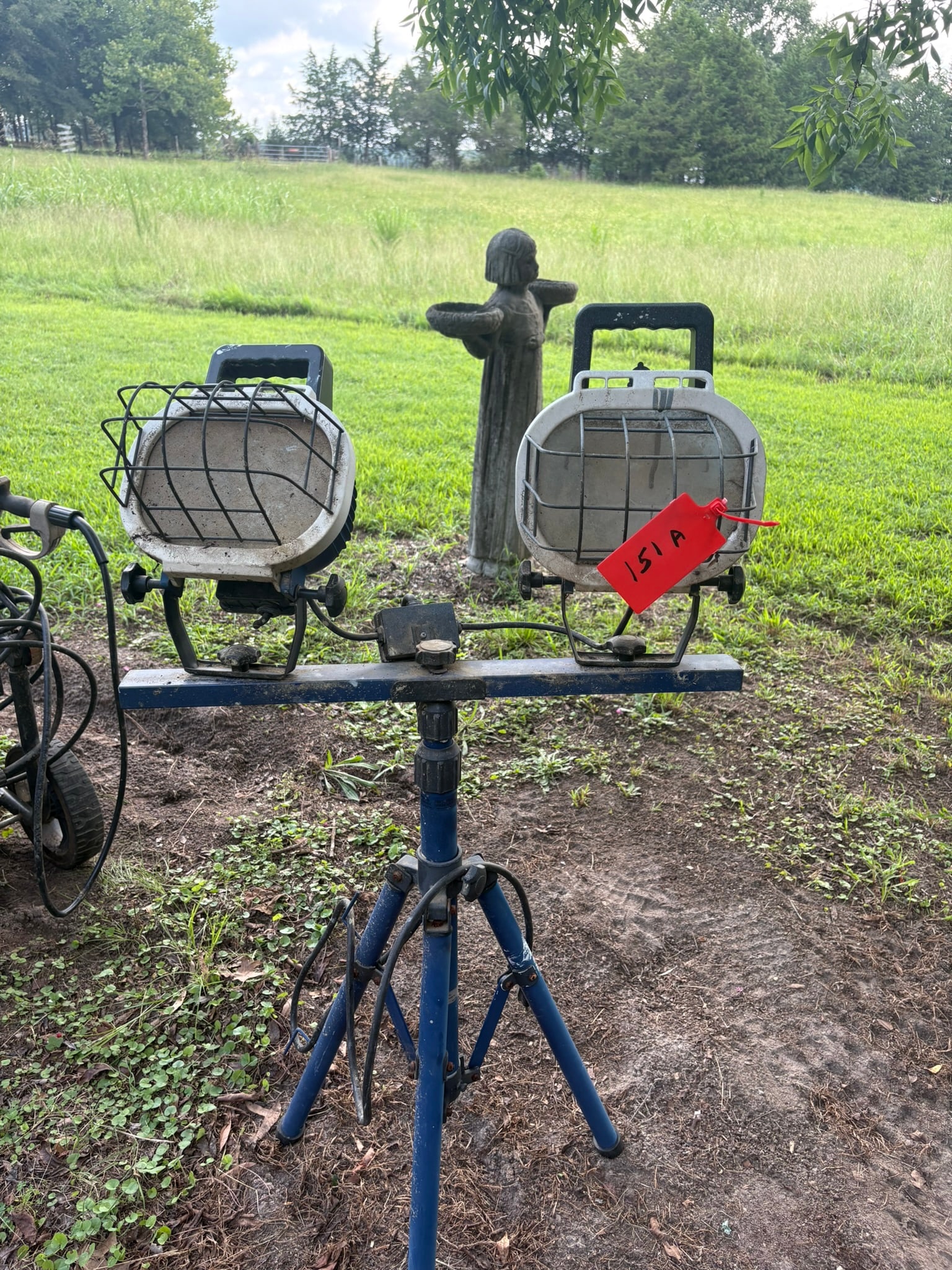 Dual-Head Portable Tripod Work Light: This heavy-duty portable work light features dual adjustable heads mounted on a sturdy, collapsible tripod stand. Designed for demanding job sites, the units are protected by integrated wire safety ca