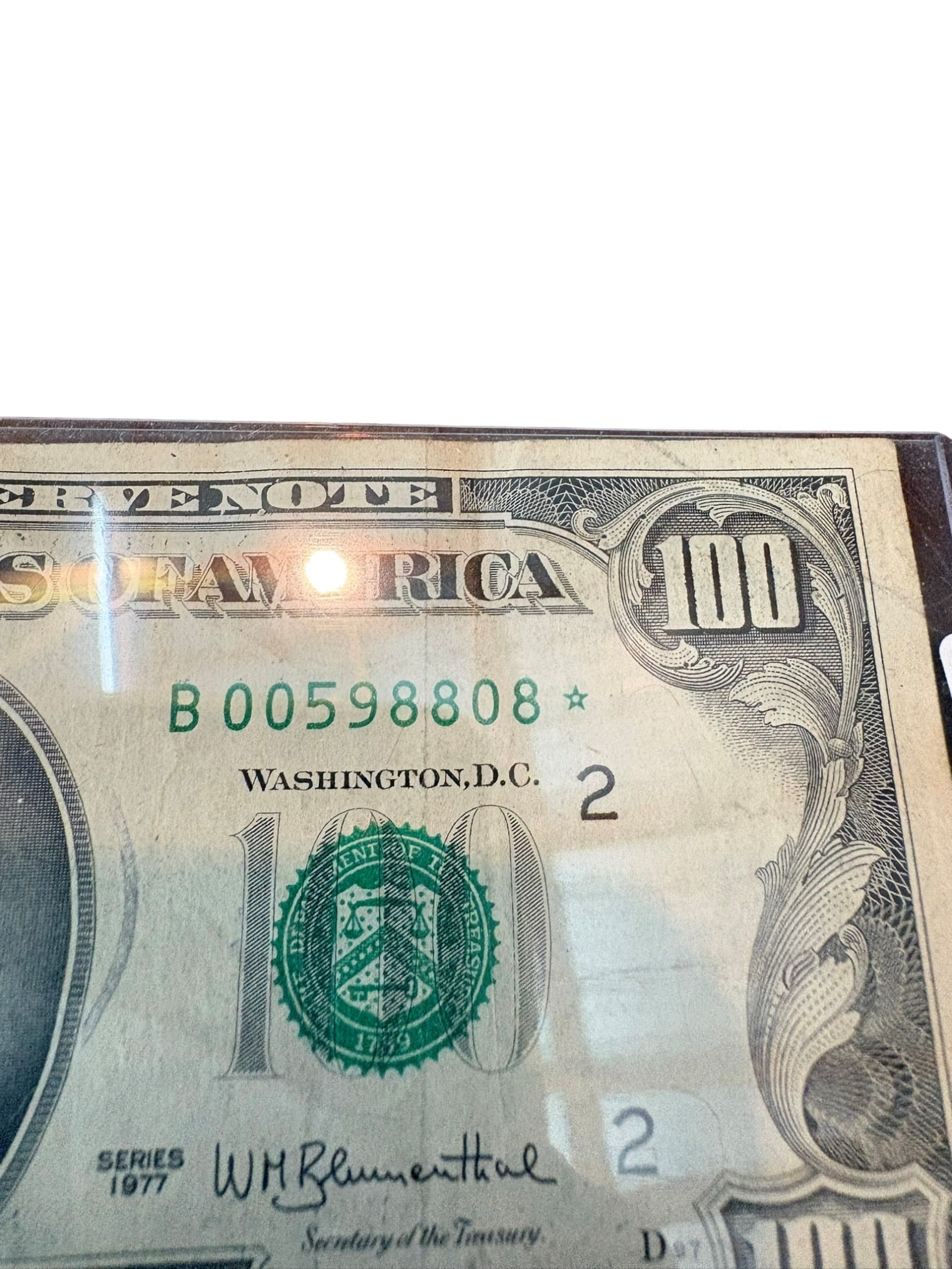 1977 United States Federal Reserve One Hundred Dollar Star Note: This is a Series 1977 United States Federal Reserve $100 bill, identifiable as a 'star note' due to the star suffix on the serial number, indicating it is a replacement note. The note features the
