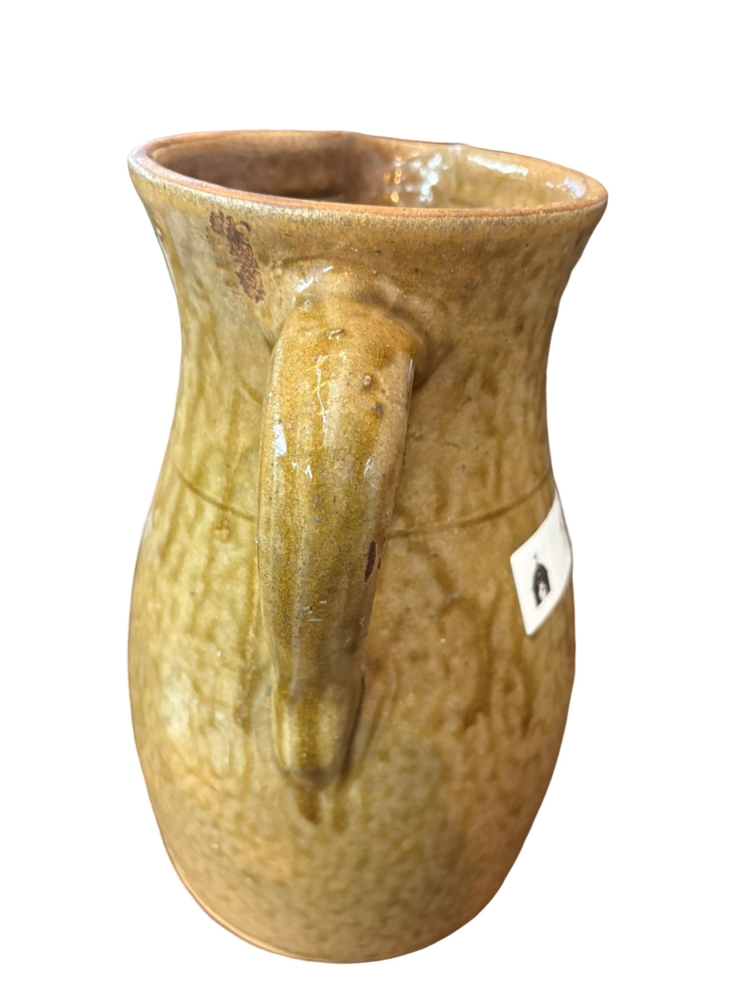 Southern Alkaline-Glazed Stoneware Pitcher: An attractive example of Southern alkaline-glazed stoneware, this pitcher features a classic bulbous form with a nicely defined rim and an applied handle. The surface is covered in a characteristic