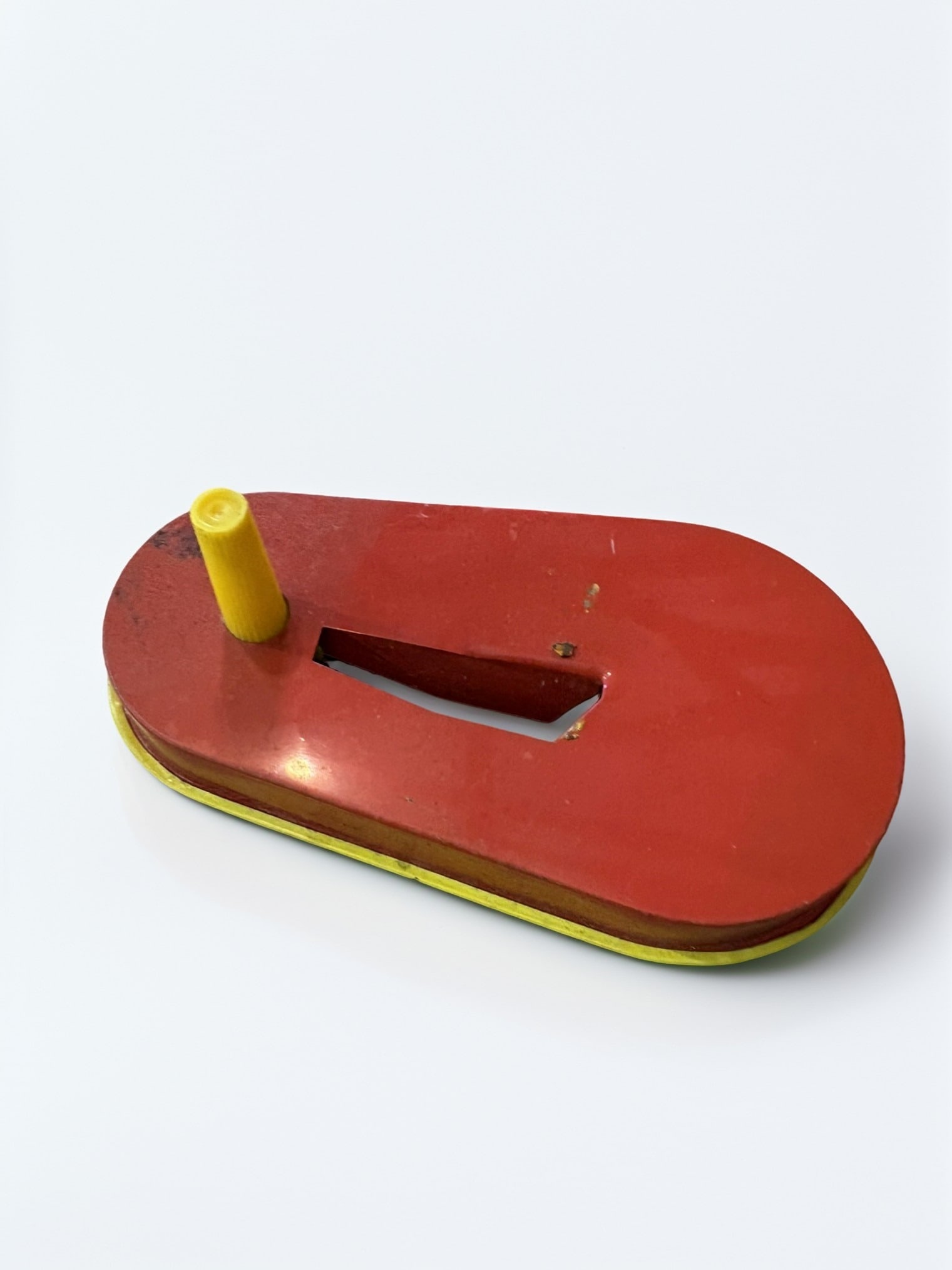 Vintage Kirchhoff Tin Lithograph Noise Maker: This vintage metal noise maker, produced by Kirchhoff, features vibrant lithographed illustrations of a jester and a woman on a bright yellow background. The reverse side is finished in a contrasting 