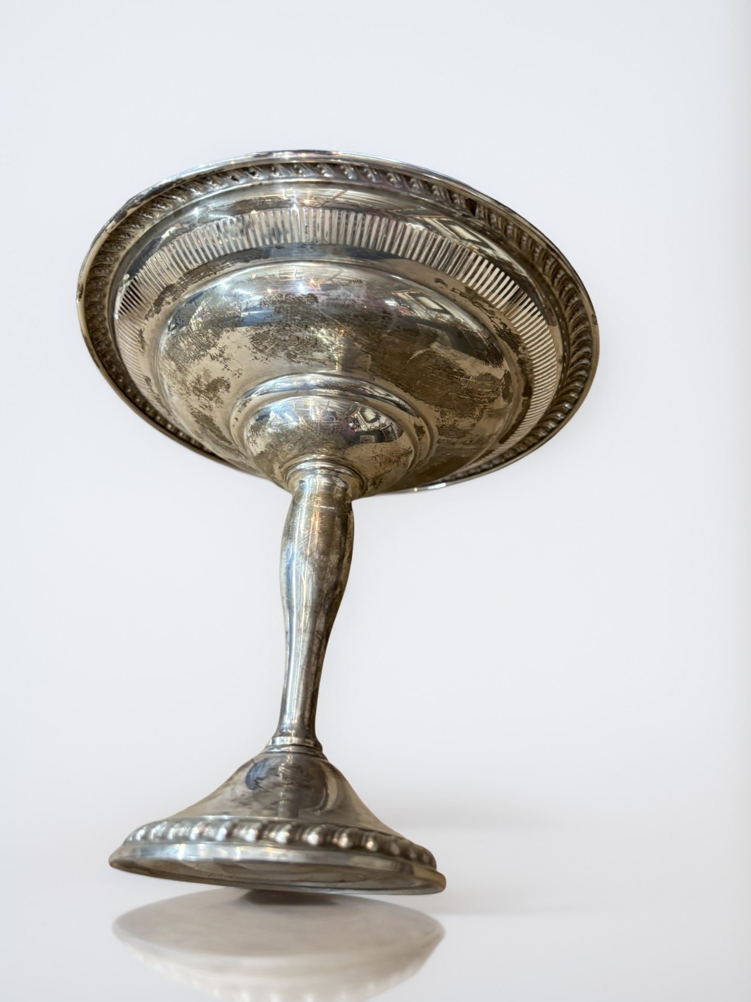 American Sterling Silver Tazza: This elegant pedestal tazza or comport is crafted from American sterling silver, featuring a classic design with a beaded rim and a delicate openwork gallery. The piece stands on a tapered pedestal ba