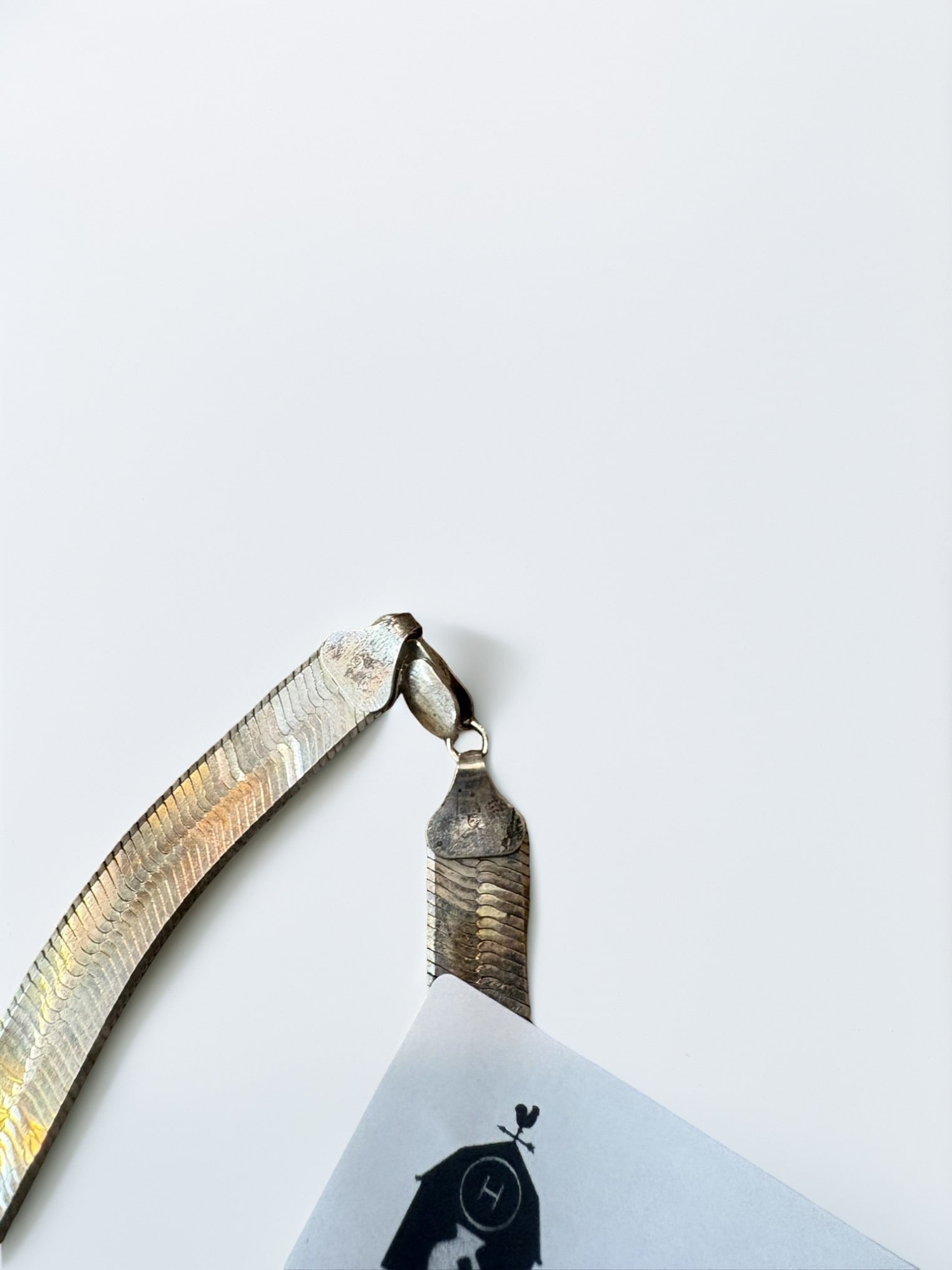 Sterling Silver Herringbone Chain Necklace: This classic herringbone chain necklace is crafted from sterling silver, featuring a smooth, flexible design that lays flat against the neckline. The necklace is secured with a sturdy lobster claw cla