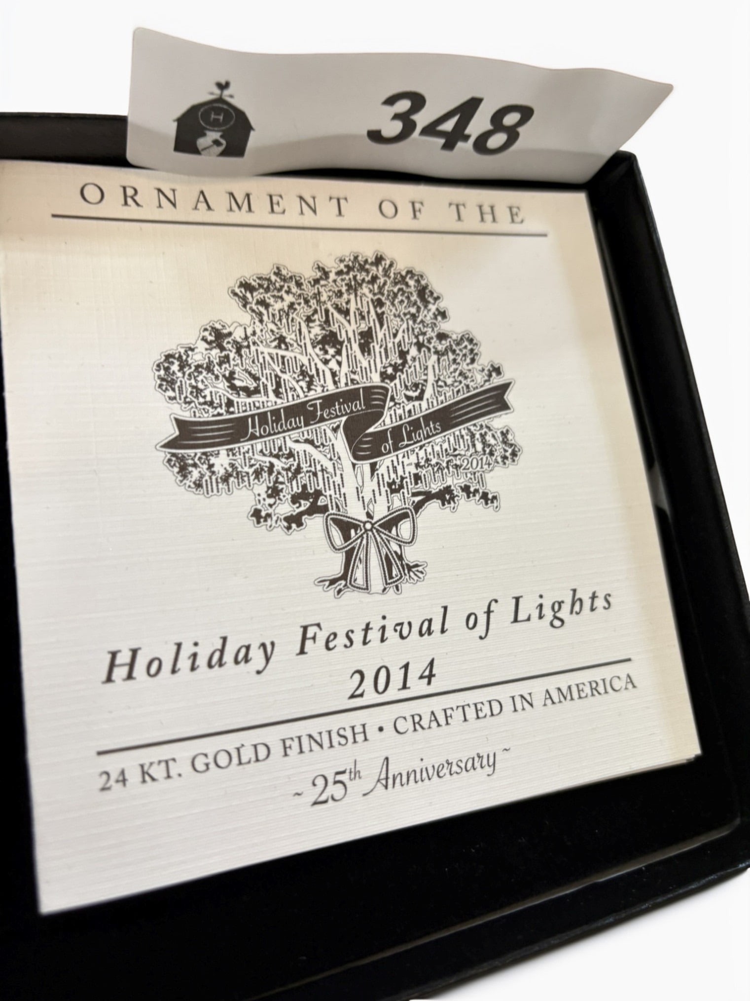 2014 Holiday Festival of Lights 25th Anniversary Ornament: This collectible 2014 Holiday Festival of Lights ornament commemorates the event's 25th anniversary. The intricately designed piece features a 24-karat gold finish and is presented in its original dis