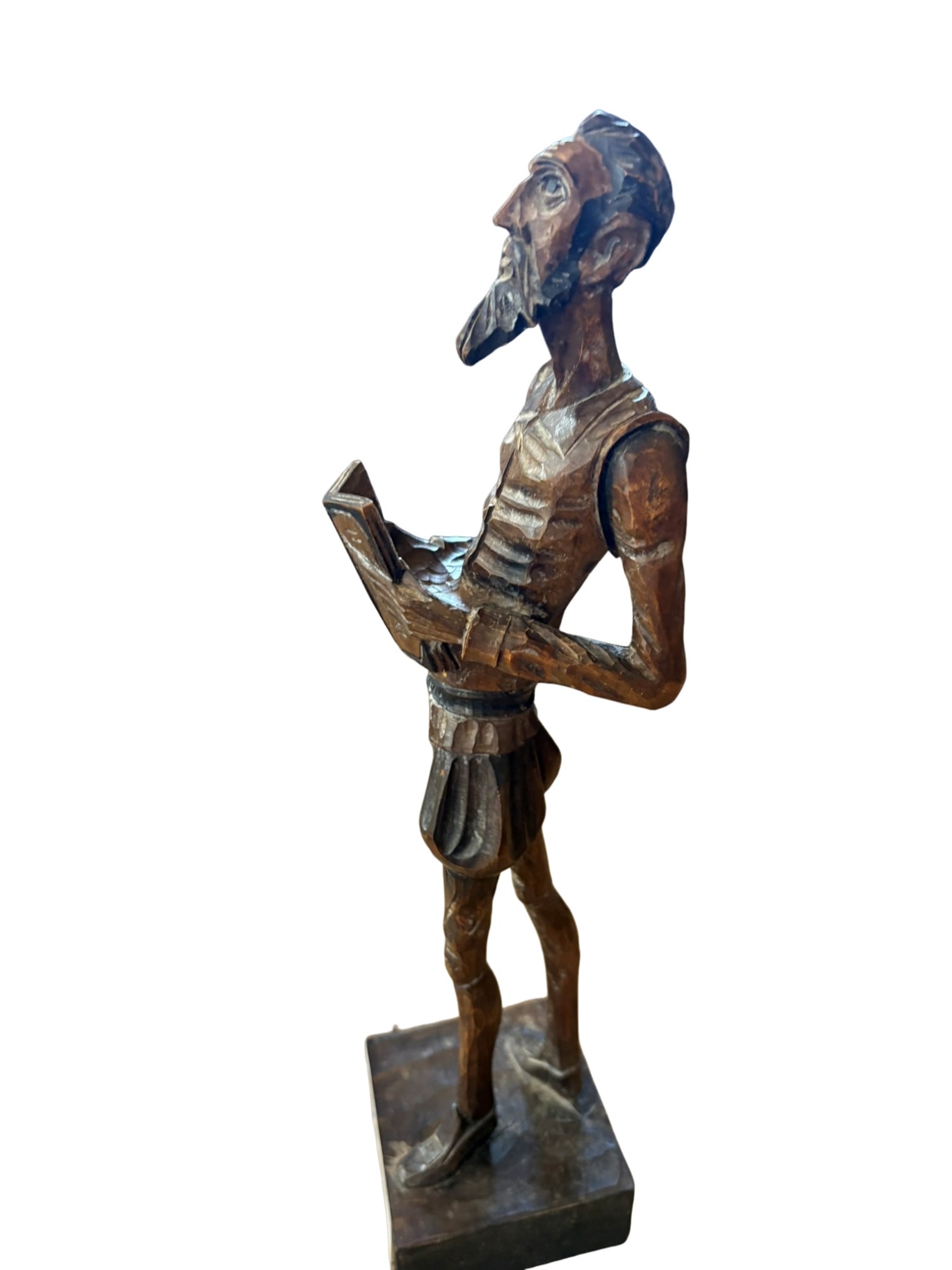 Carved Wood Sculpture of Don Quixote: This hand-carved wooden sculpture depicts the literary figure Don Quixote. The stylized artisan piece features the iconic, elongated features characteristic of the knight-errant, shown in a contemplat