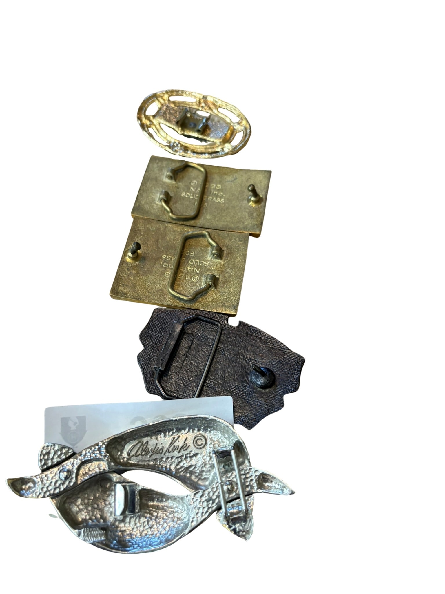 Collection of Vintage Designer and Collectible Belt Buckles: This diverse collection features a variety of vintage belt buckles, highlighting unique styles and makers. Included are two solid brass rectangular buckles with waterfowl enamel scenes, an ornate