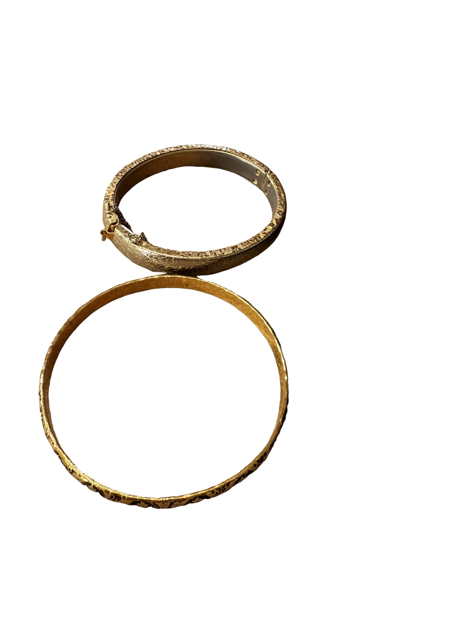 Collection of Vintage Costume Jewelry and Silvered Hand Mirror: This lot features a diverse collection of vintage costume jewelry, including several bangles, a cuff bracelet with an inset stone, and a decorative floral-motif accessory. Accompanying the jewelry is