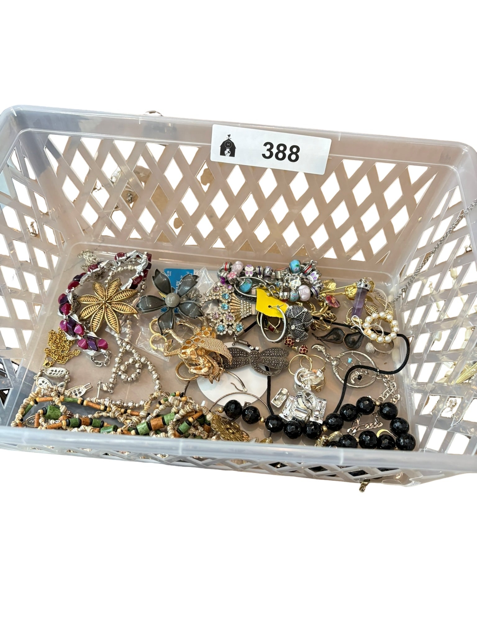 Assorted Costume Jewelry Lot: This miscellaneous collection features a diverse assortment of costume jewelry pieces, including beaded necklaces, fashion brooches, bracelets, and earring sets. The group encompasses a wide variety o