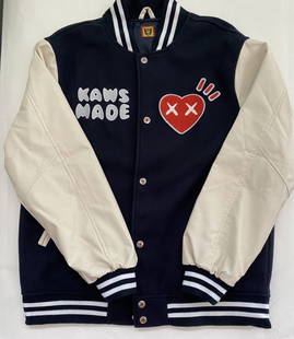 Kaws x Human Made - Varsity Jacket, 2021: Kaws x Human Made - Varsity Jacket, 2021Rare Varsity Jacket with ribbed cuffs, welt pockets, the design is completed by the artist's signature on the "eyes" of the heart-shaped application and the