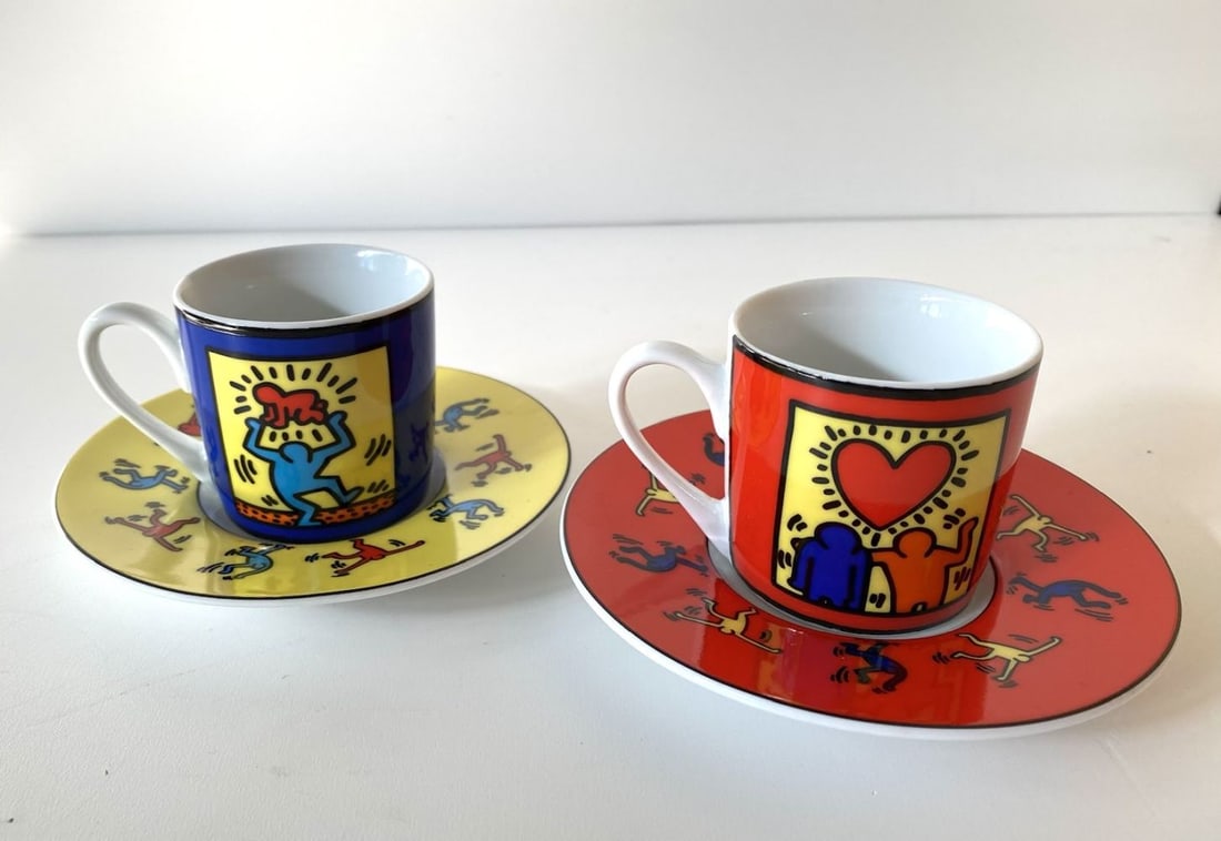 Keith Haring (after) - set of 2 espresso cups and saucers: Keith Haring (after) - set of 2 espresso cups and saucersSet of 2 espresso cups and saucers, printed with colorful motives by Keith Haring. Bottoms marked “Keith Haring by Konitz”. Cup size: h