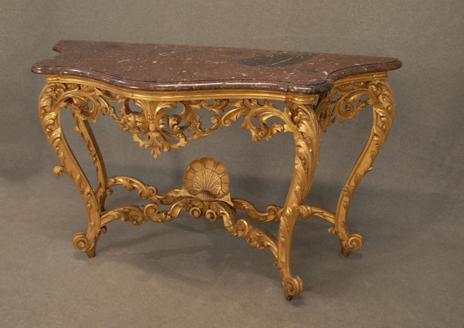 Consolle in legno.: Consolle in legno intagliato e dorato con piano in marmo. XIX secolo. Difetti. Mis. Lung. cm. 173 Alt. cm. 102 Prof. cm. 64 ca. Val. 1800/3000