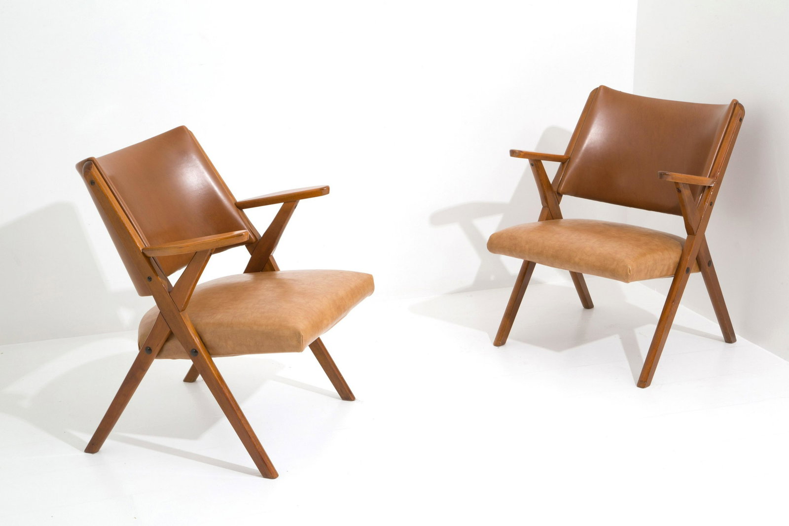 Pair of armchairs. Production DAL VERA.: Pair of armchairs in wood and leather. Production FROM REAL, Conegliano Veneto. 1950s. With authenticity stamp. Good condition, signs of wear dictated by time. Inspired by the Nordic design of the CH2