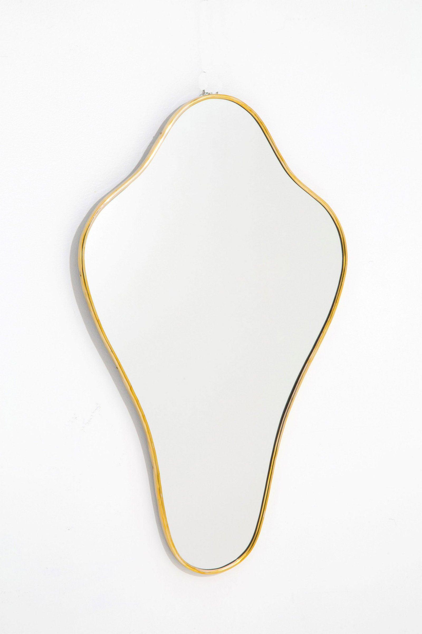 Shaped mirror: Shaped mirror in brass. Italian manufacture. 1950s. 68.5x41.5 cm approx. Specchio sagomata in ottone. Manifattura italiana. Anni '50. 68,5x41,5 cm ca.