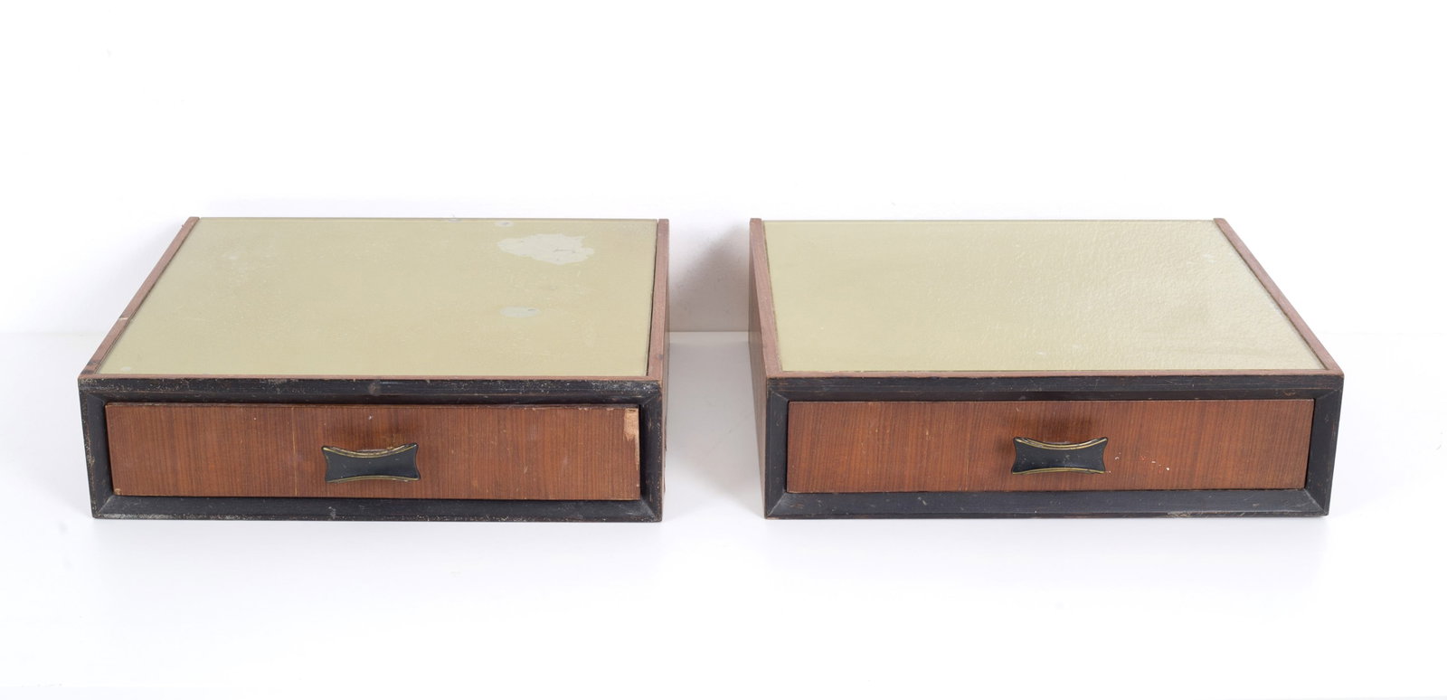 Pair of hanging bedside tables in wood and glass: Pair of wooden hanging bedside tables with back-painted glass top and a drawer on the band with black painted metal handles. Italian manufacturing. 60's. Defects and signs of wear over time. 11x40x35 