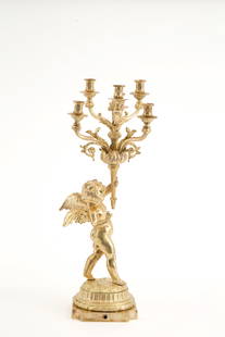 Candelabra with putto in gilded bronze: Six-flame candelabra with putto in gilded bronze. Early 20th century. Defects. Height approx. 66 cm. Candelabro sei fiamme con putto in bronzo dorato. Inizi XX secolo. Difetti. Alt. 66 cm ca.