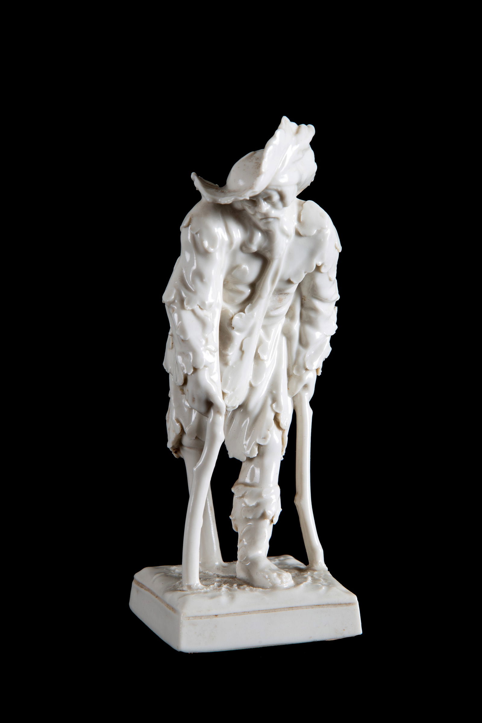 Sculpture "BEGGAR". CAPODIMONTE: White porcelain sculpture depicting "BEGGAR." CAPODIMONTE manufacture. Marked on the bottom. 20th century. 15x7.5x7.5 cm approx. Scultura in porcellana bianca raffigurante ?MENDICANTE?. Manifattura CA