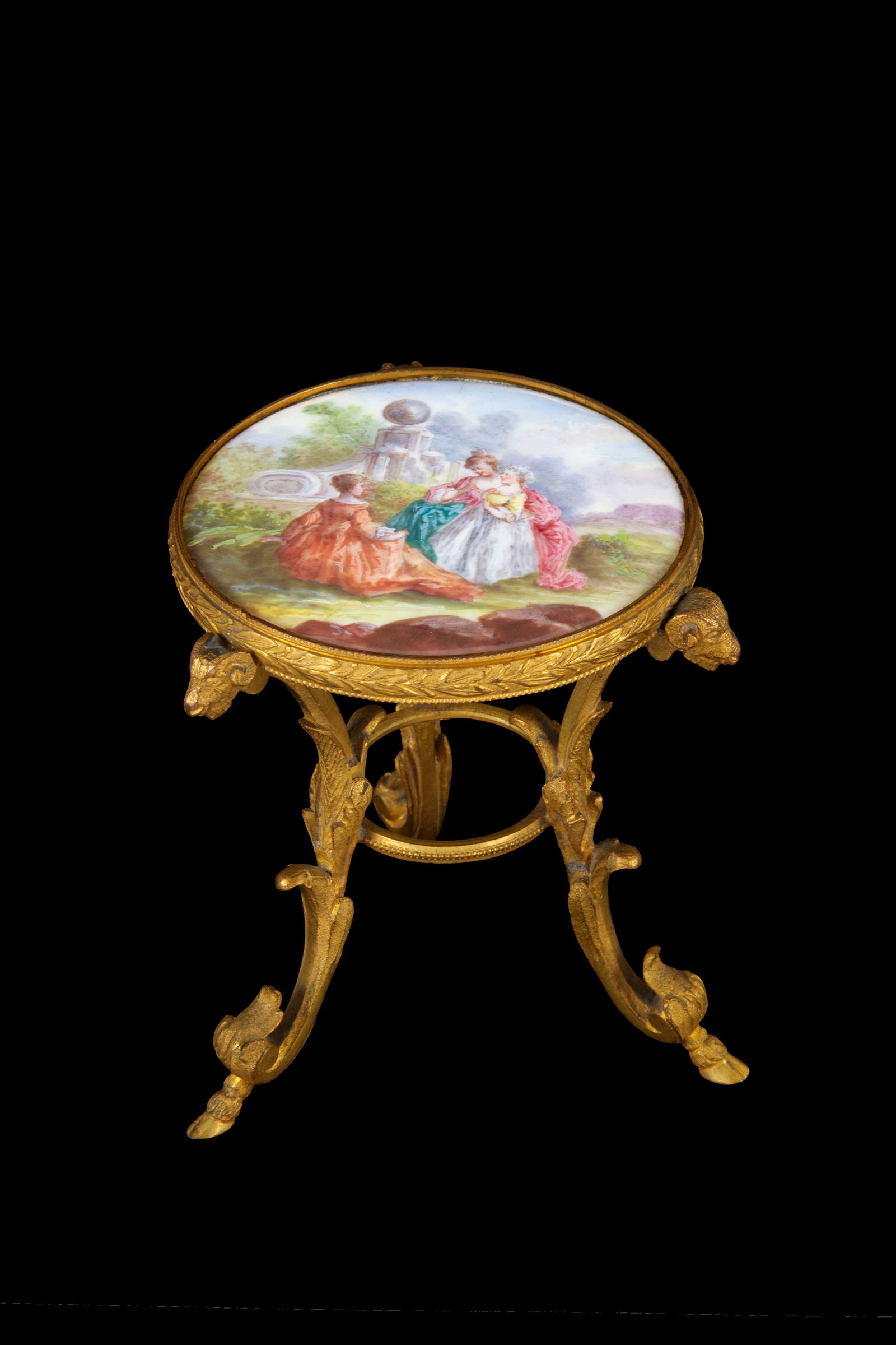 Model of a round table: Model of a round table in finely chiseled, gilded, and enameled brass, depicting young girls in the park. Vienna. Second half of the 19th century. 9.5x9 cm approx. Modellino di tavolo rotondo in otton