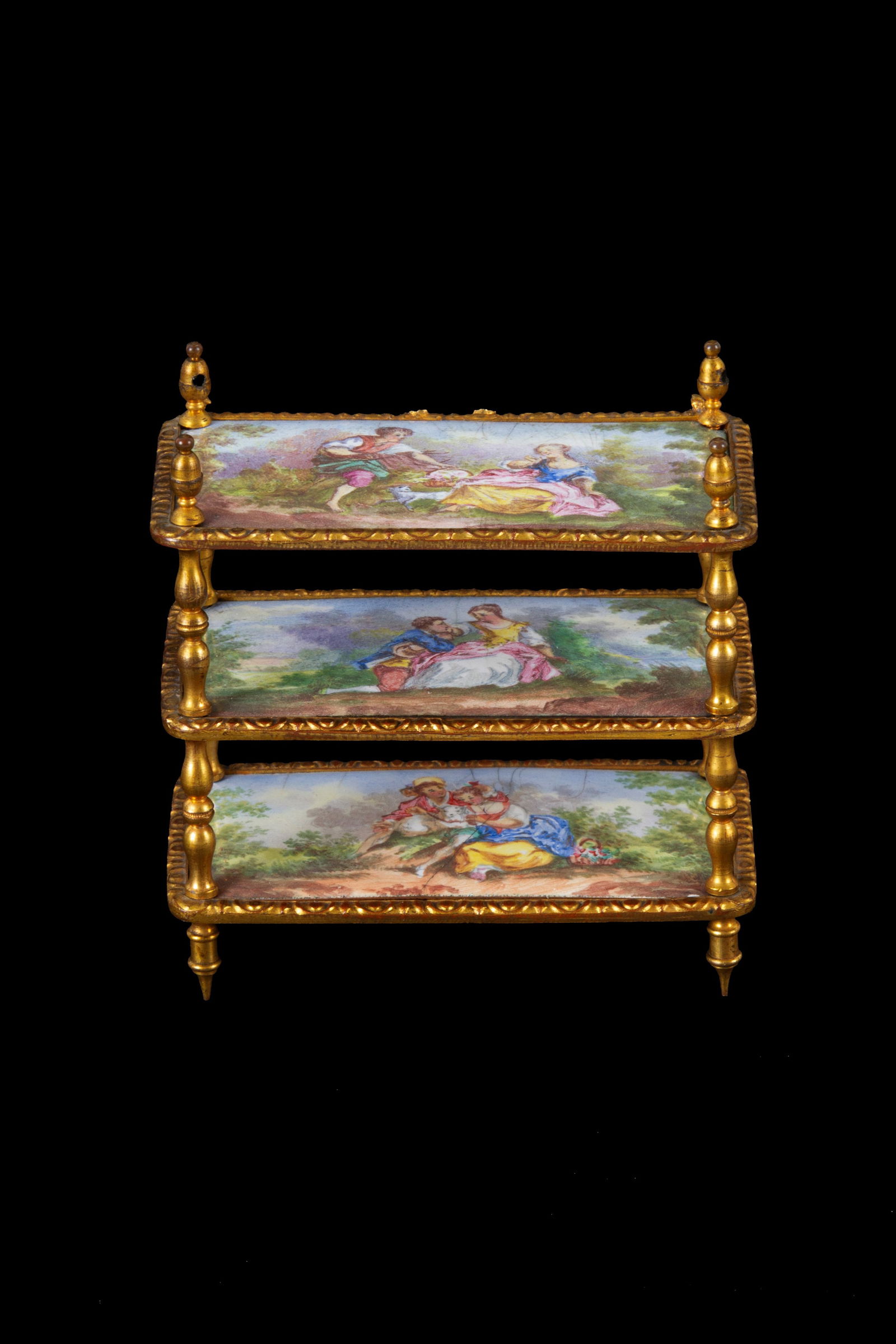 Model of a brass etagere: Model of a finely chased, gilded, and enameled brass etagere with romantic scenes. Vienna. Second half of the 19th century. 7.5x7x4 cm approx. Modellino di etagere in ottone finemente cesellato,