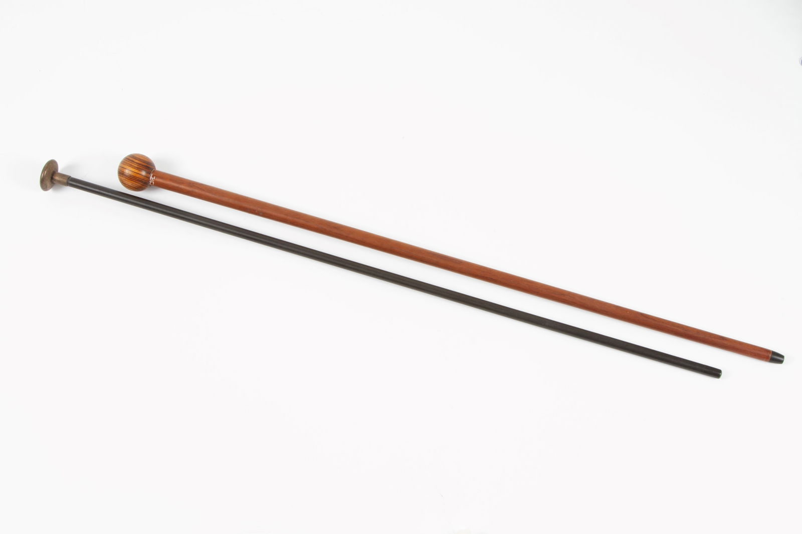 Two walking sticks with knobs in violet wood and metal (1 of 3)