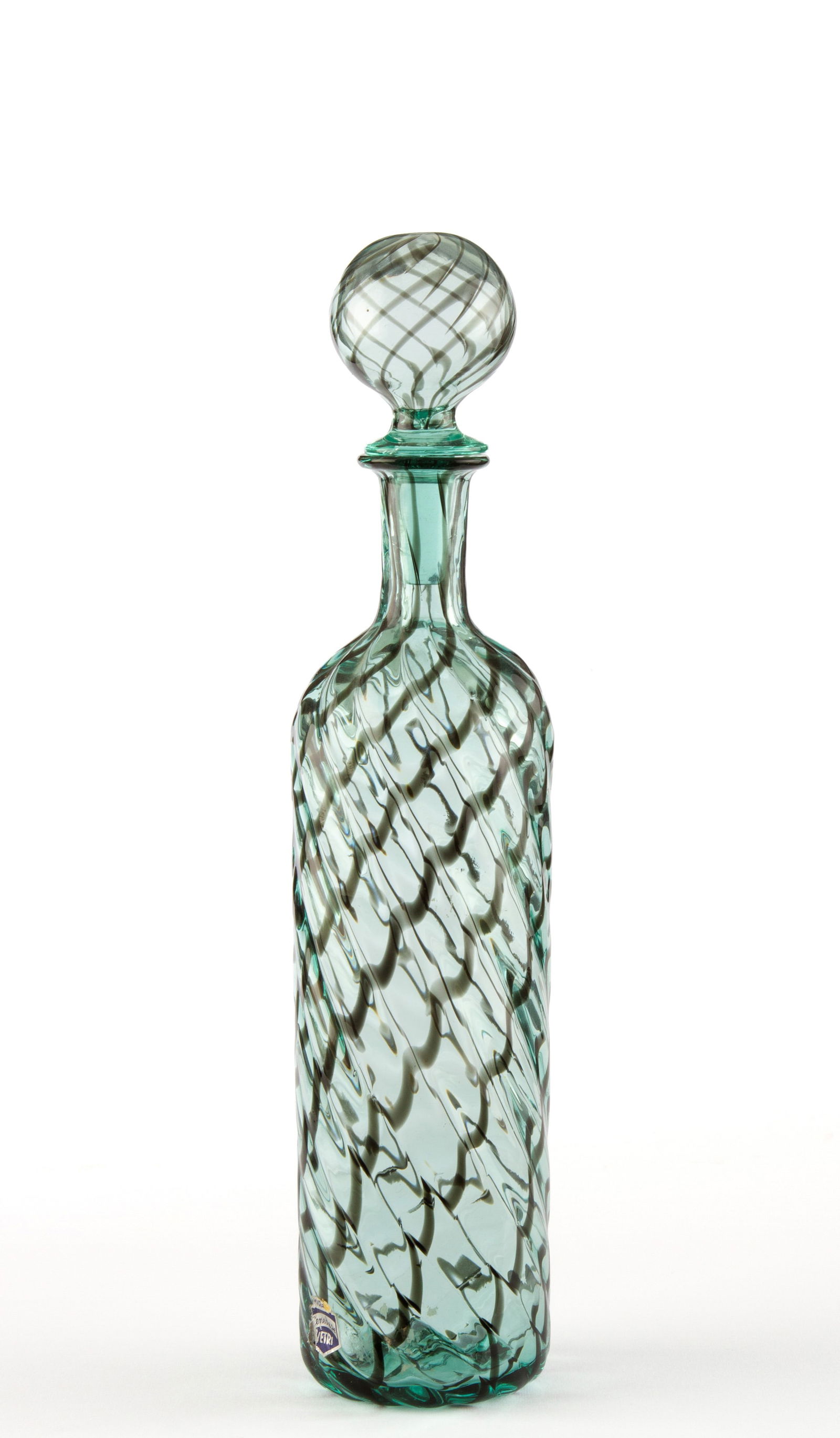 Blown glass bottle. CENEDESE: Blown glass bottle in shades of green and black. CENEDESE manufacture. Signed on the bottom and labeled at the base. Height approx. 34 cm. Bottiglia in vetro soffiato nei toni del verde e nero.