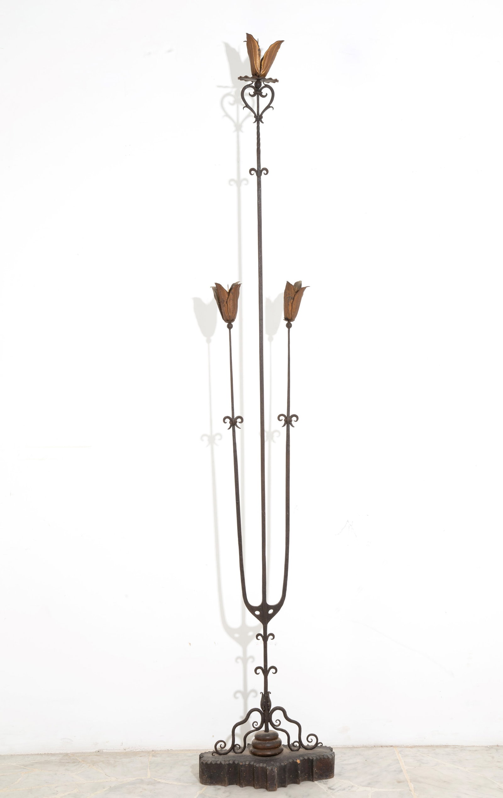 Portaceri: Wrought iron and gilded sheet metal candlestick. Wooden base. 19th century. Defects. Height approx. 195 cm. Portaceri in ferro battuto e lamierino dorato. Base in legno. XIX secolo. Difetti. Alt. 195