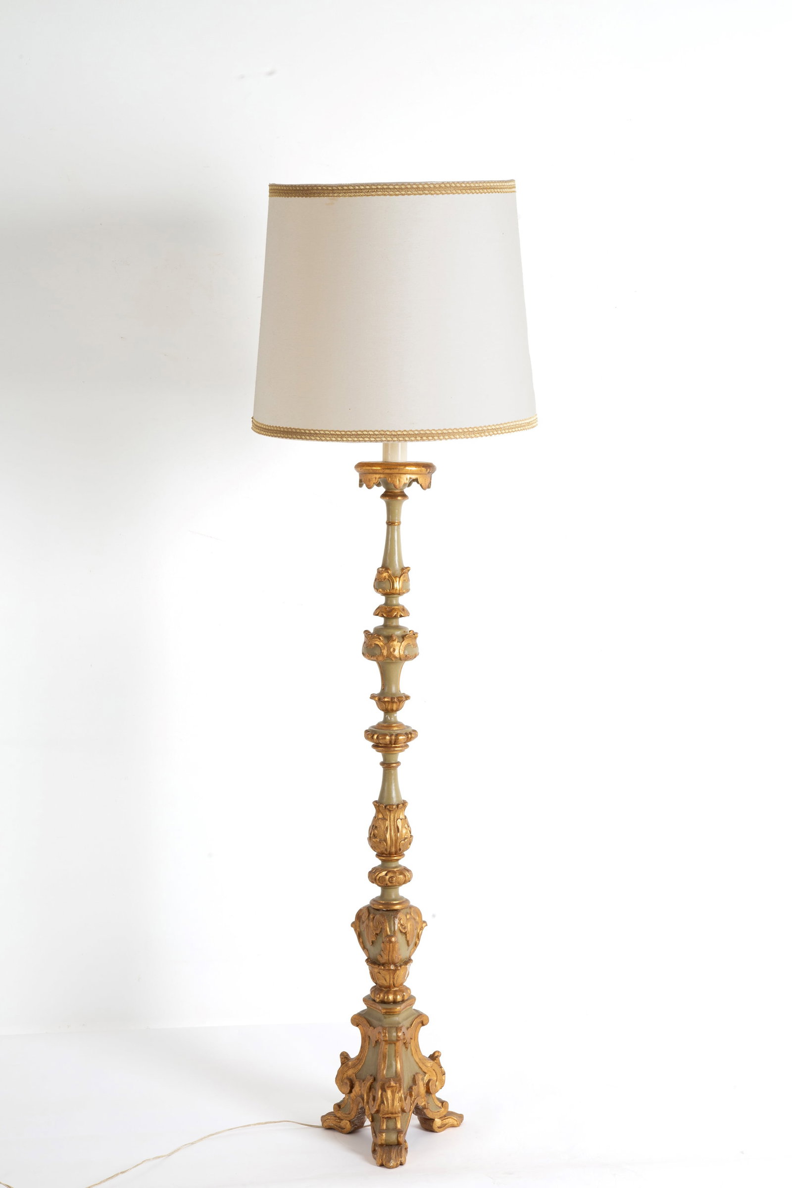 Candeliere trasformato a lampada: A carved, lacquered, and gilded wooden candlestick converted into a lamp. Late 19th century. Minor defects. Height approx. 120 cm. Candeliere trasformato a lampada in legno intagliato, laccato e