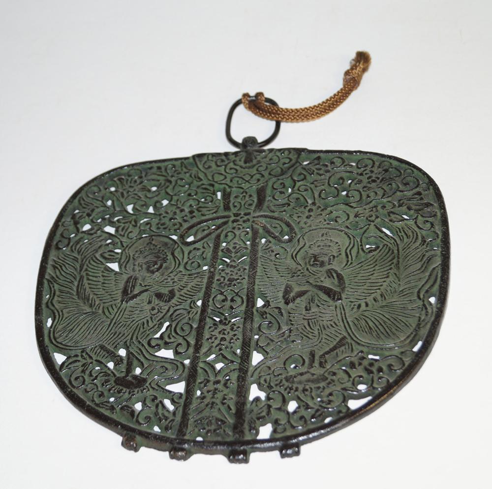 Japanese Antiques Decorative bronze ornament, replica: Japanese Antiques Decorative bronze ornament, replica 22 x 24 cm. Heavy bronze disc, dark patinated, black back. In flat relief two tennins and in breakthrough lotus tendrils. On the back label Fumido