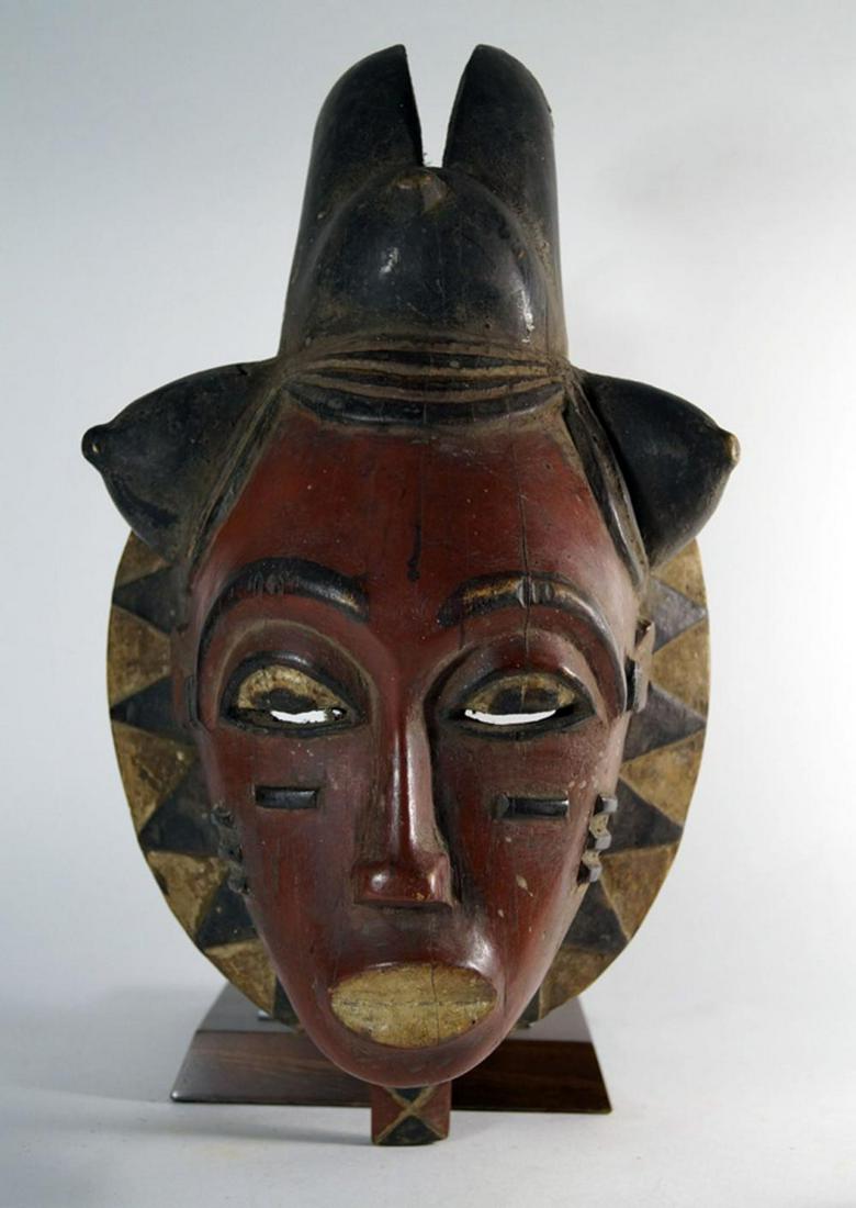 African Art- Mask type Mdoma of the Mblo Group, Ivory: African Art- Mask type Mdoma of the Mblo Group, Ivory Coast Baulé H. 37 cm. Heavy wood, oil painting in dark red, black and white. Expressive mask of oval basic shape, consisting of a formed and